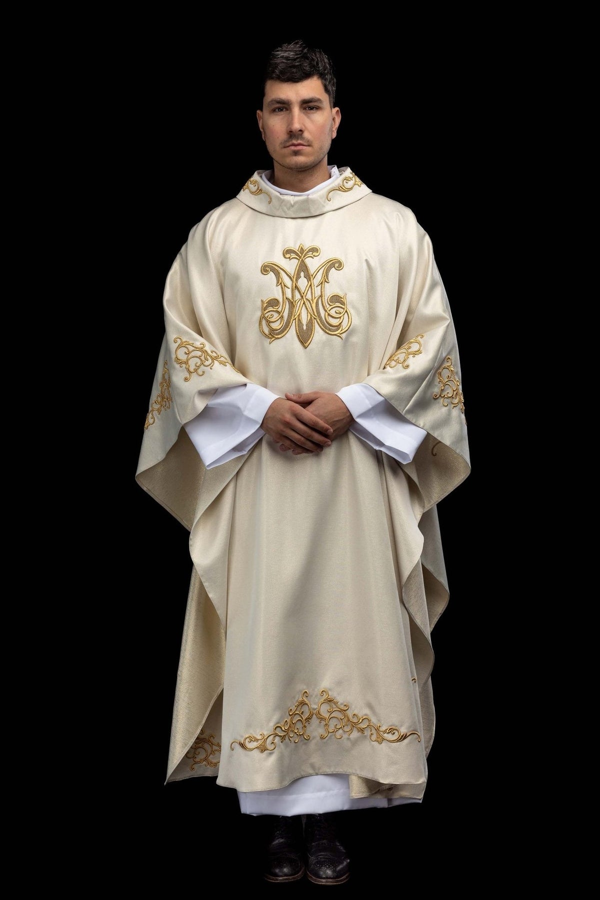 Marian chasuble front view with gold Marian symbol and embroidered sleeve motifs