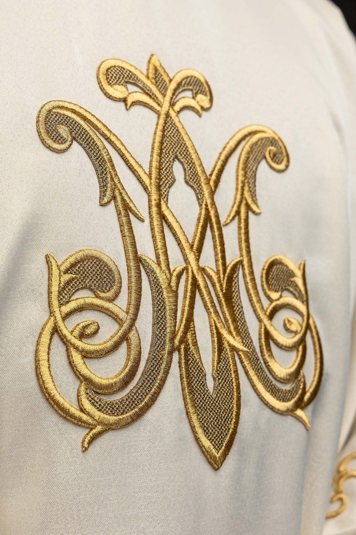 Marian chasuble close-up of gold embroidered Marian symbol