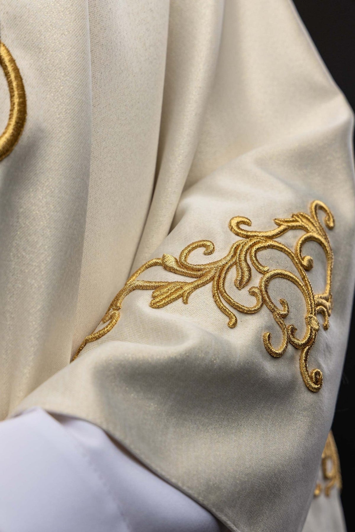 Marian chasuble close-up of gold scroll embroidery on sleeve