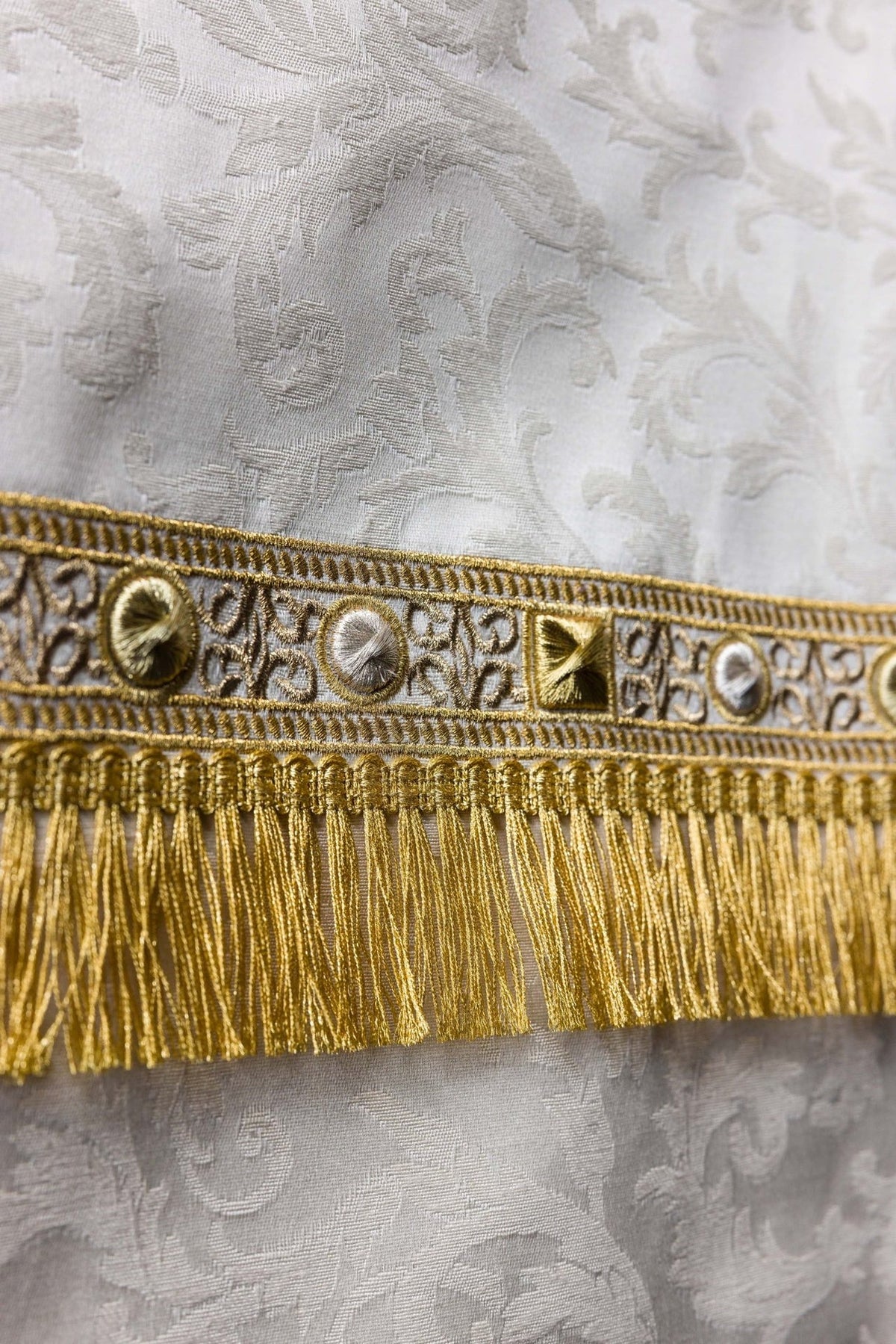 Church lectern cover close-up of gold embroidered trim and fringe