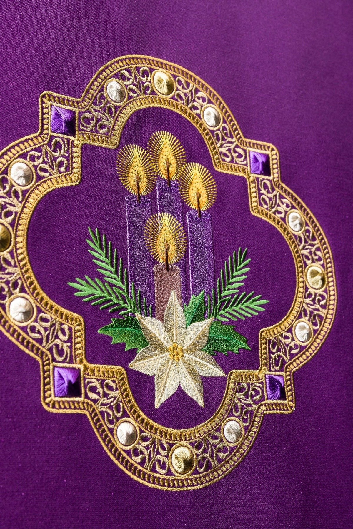 Purple church lectern cover close-up of Advent embroidery with candles and poinsettia
