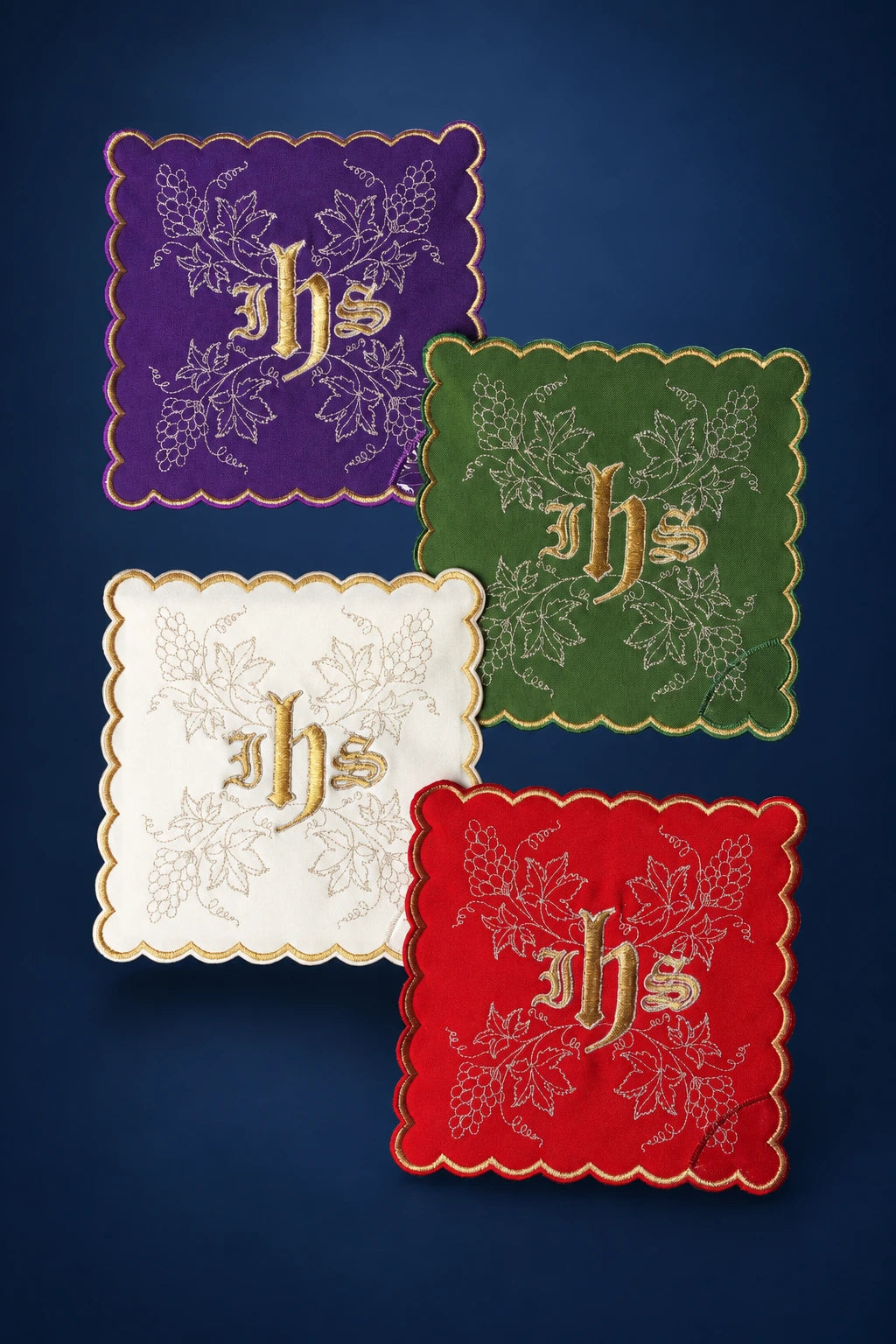 Set of four scalloped chalice palls in purple, green, white, and red with IHS and vine embroidery