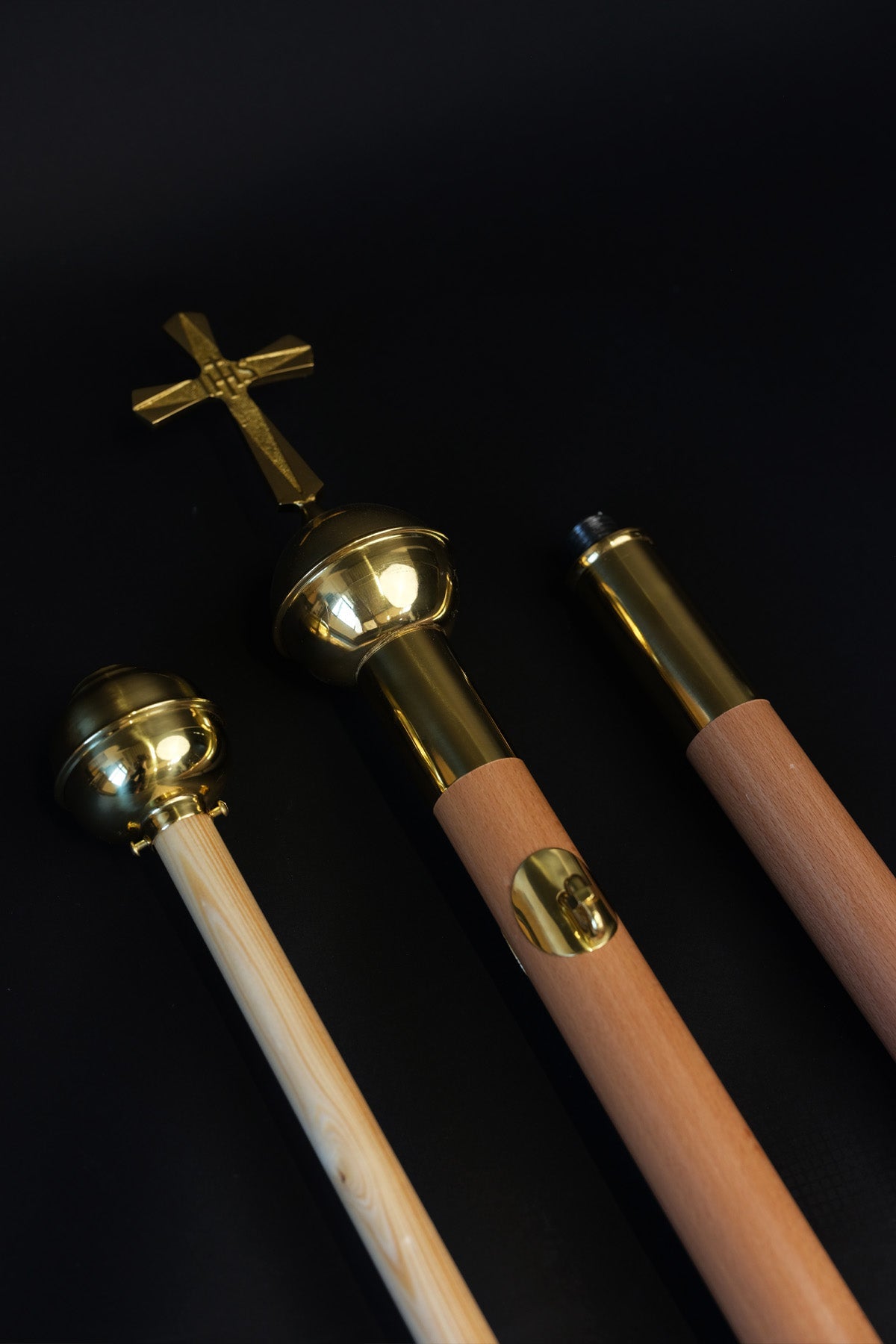Light wood banner pole, disassembled sections with gold cross and finials