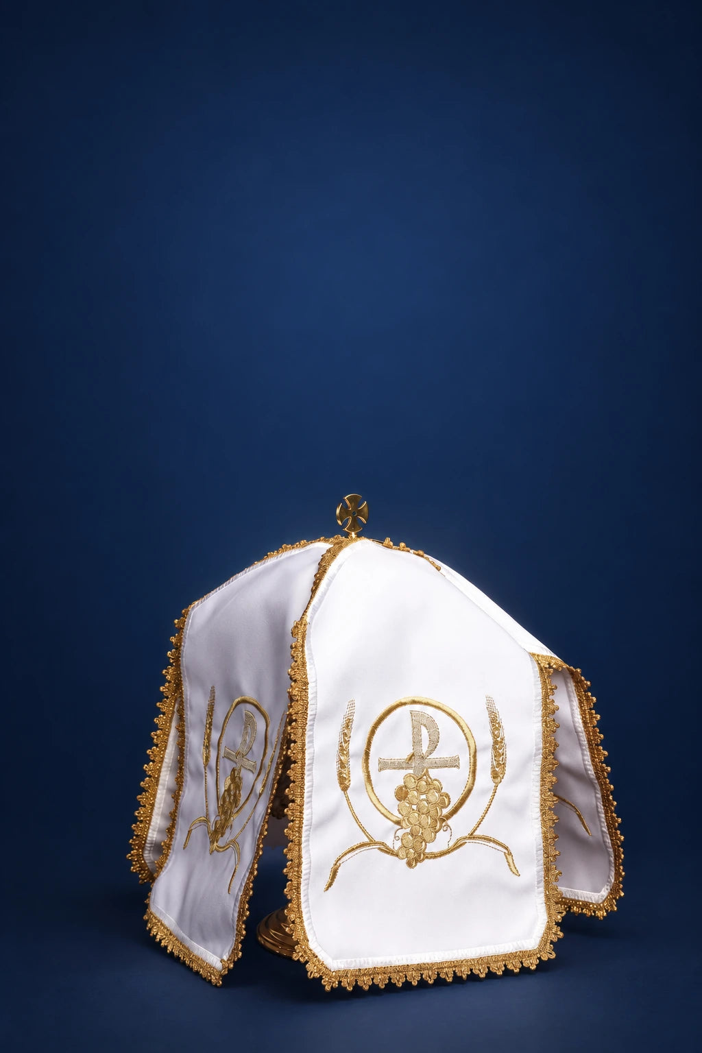 White ciborium veil with gold trim and PAX embroidery, shown draped over a vessel