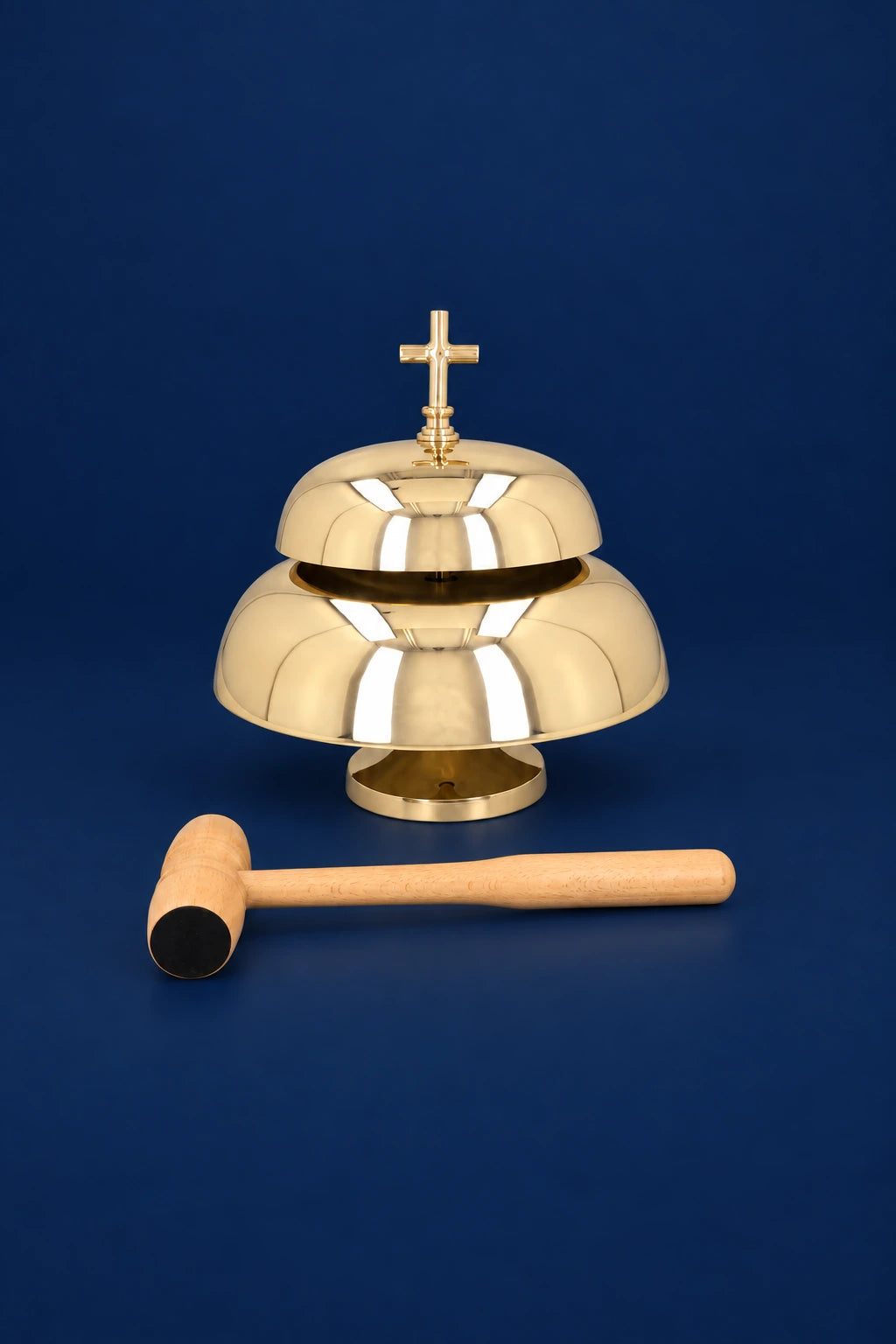 Altar bells with cross finial and wooden mallet, front view