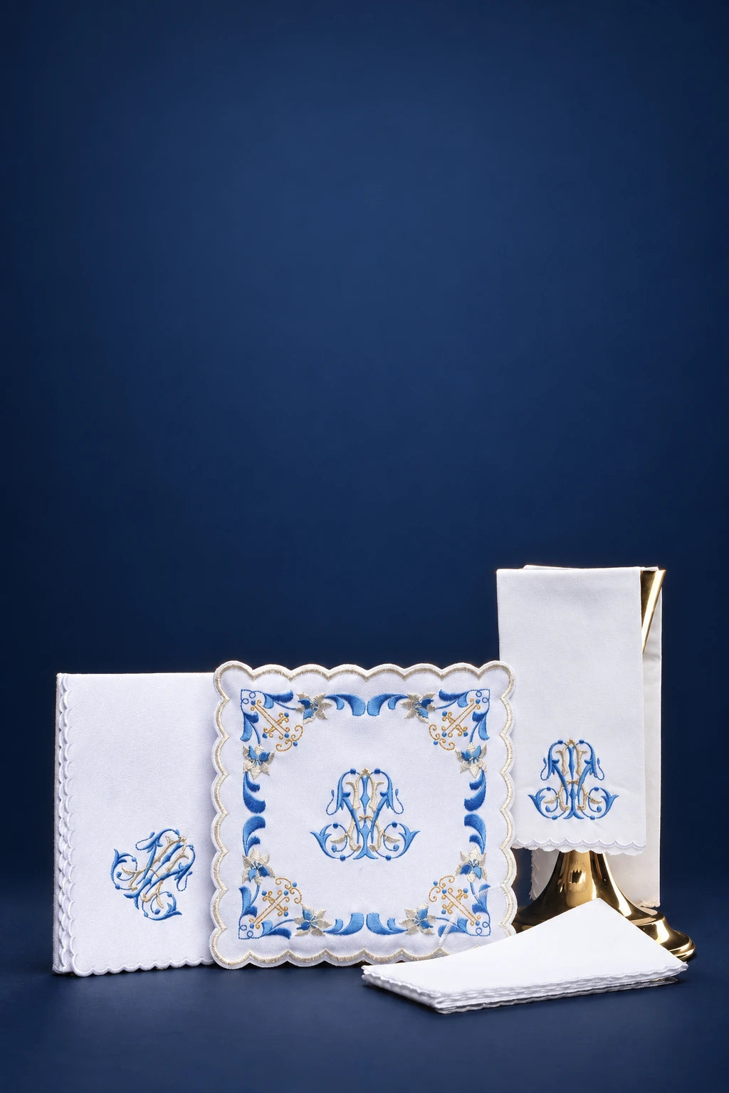 Altar linen set with blue trim and Marian embroidery, shown with square cloth, cover and folded purificators