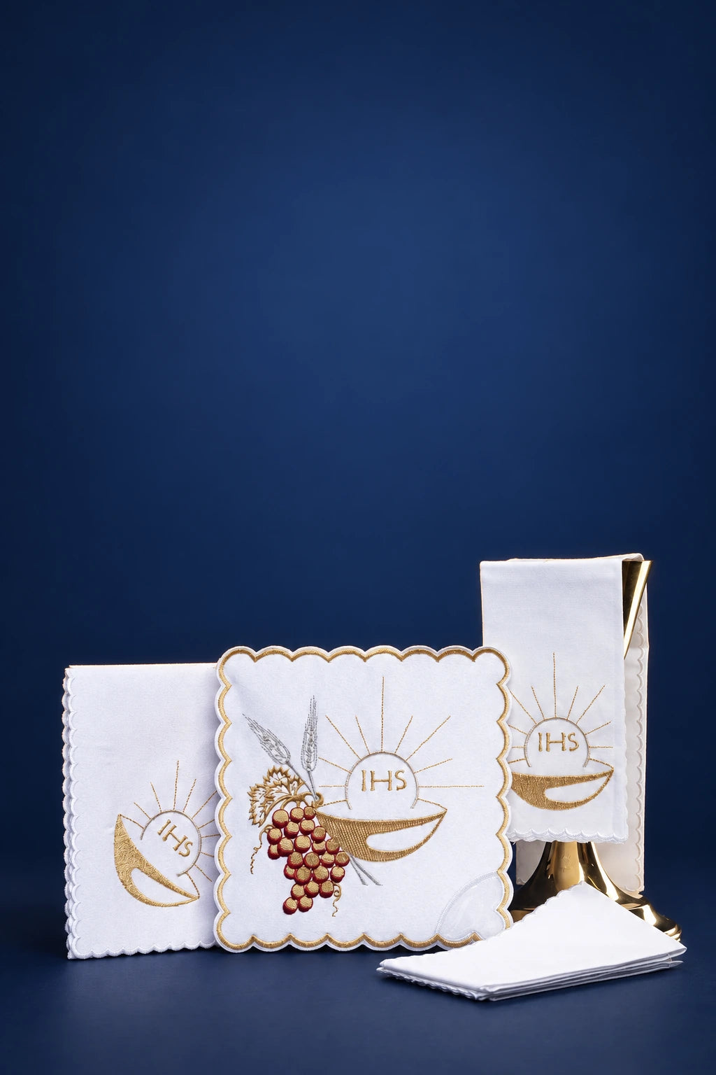 Altar linen set with chalice and IHS embroidery, shown folded with scalloped trim and grape cluster detail