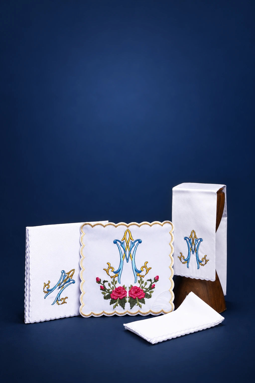Altar linen set with colorful Marian embroidery, including corporal, purificator, pall, and veil folded together