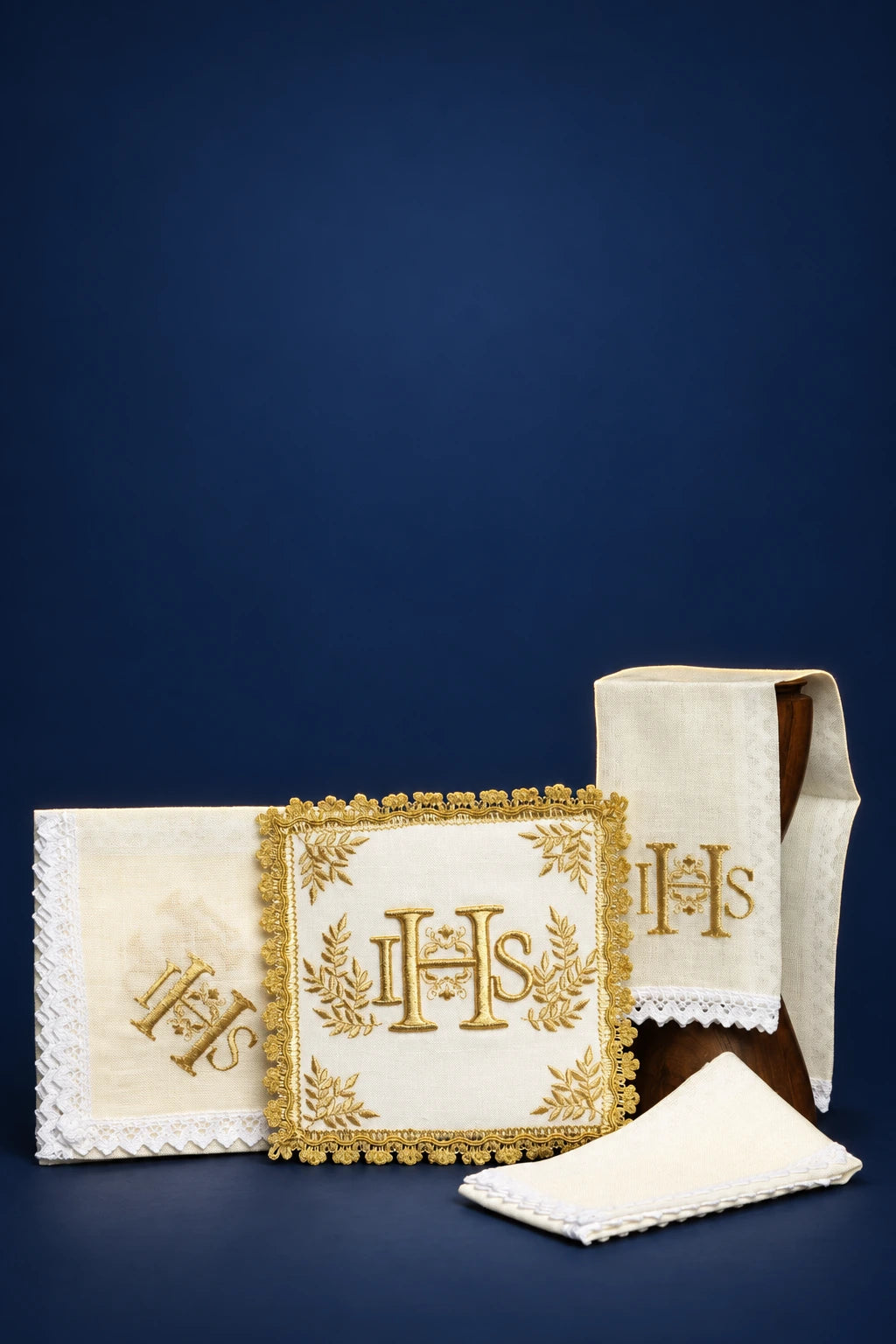 Altar linen set with embroidered IHS motif and gold trim, shown with folded cloths and purificator