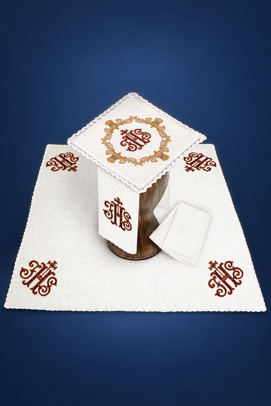 Altar linen set with embroidered IHS symbols and lace trim, shown laid flat with folded cloths