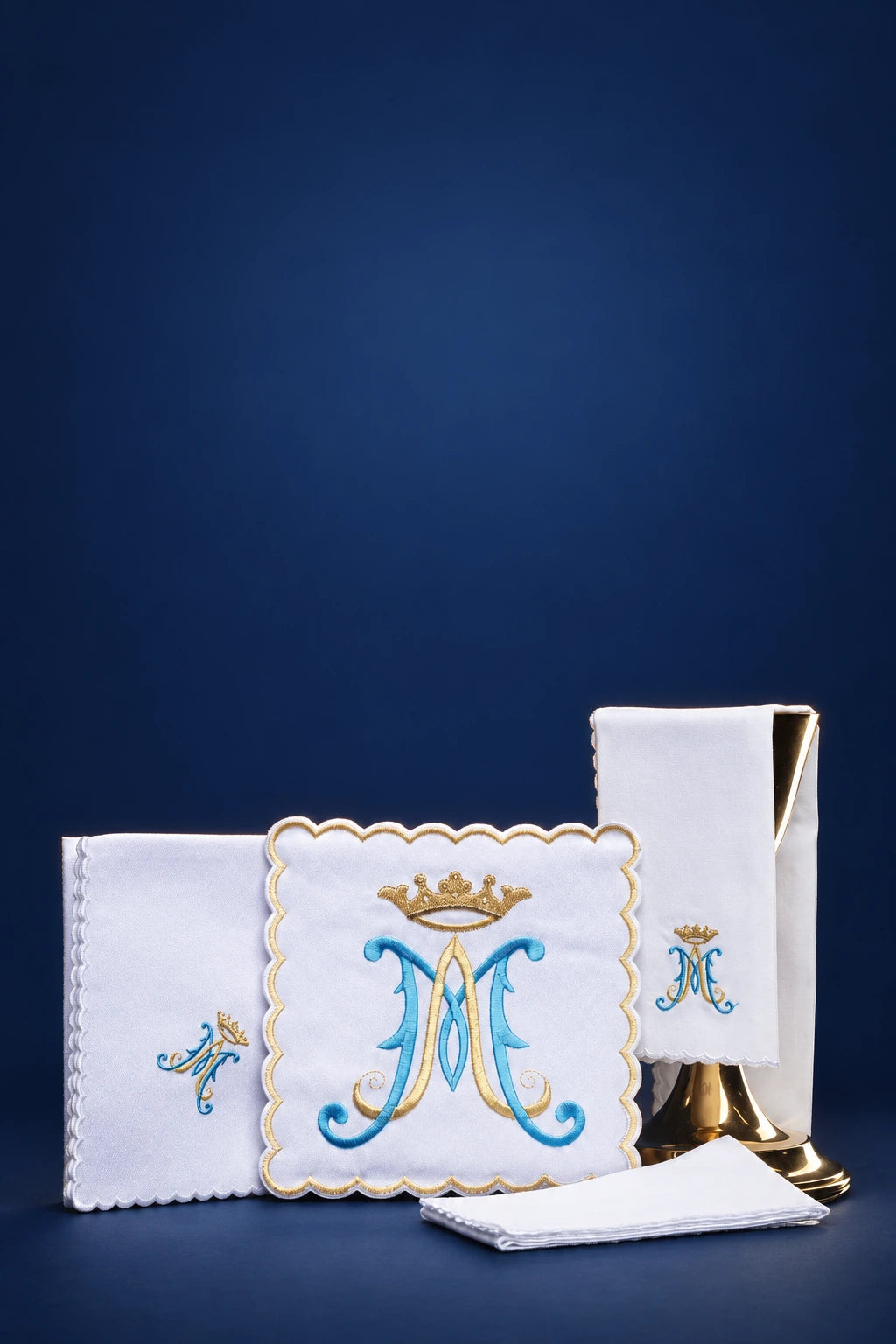 Altar linen set with embroidered Marian monogram, front view of folded purificators and corporal