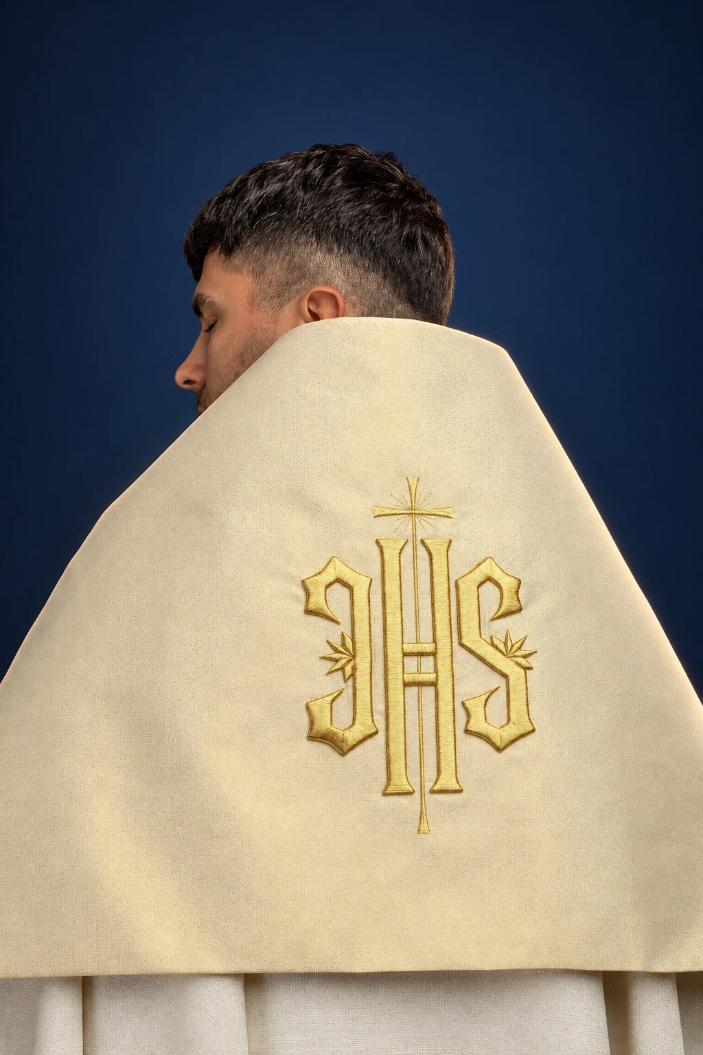 Back view of a cream humeral veil with gold embroidered IHS symbol, draped over the shoulders