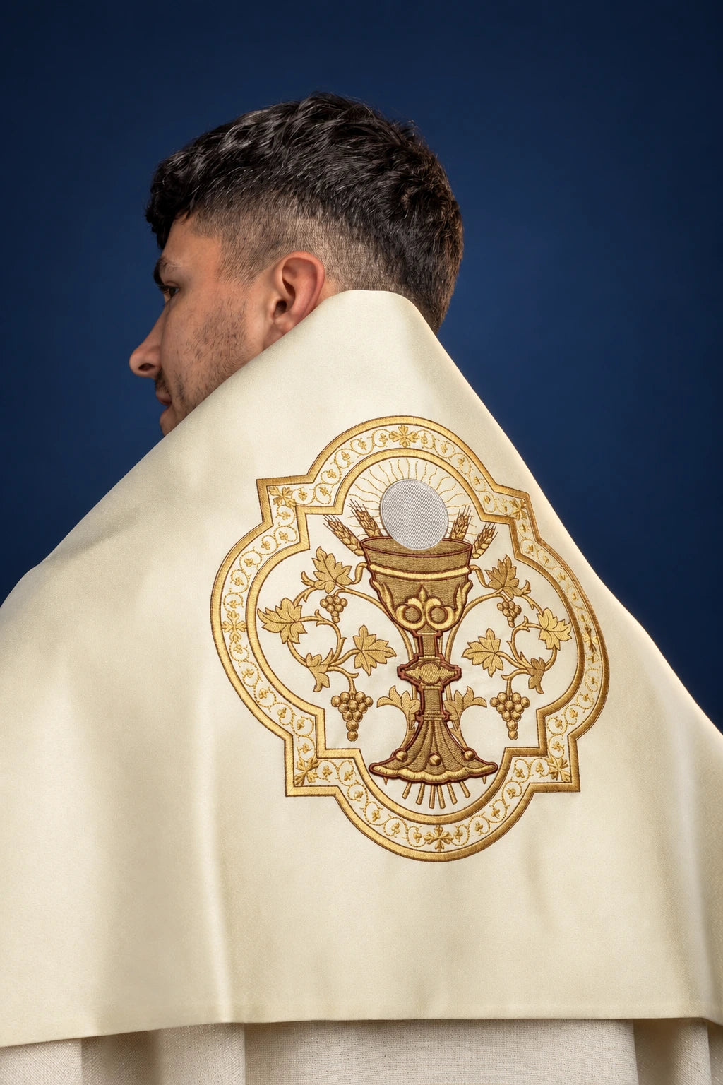 Back view of an ecru humeral veil with a large embroidered chalice and grapevine medallion on the back