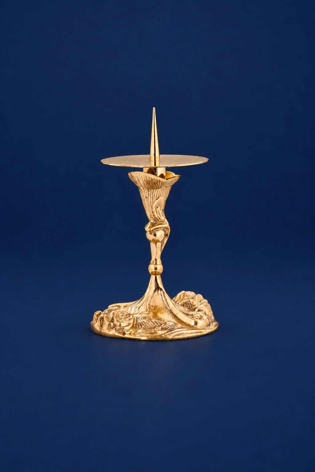 Brass candlestick, full view, with a floral motif at the base