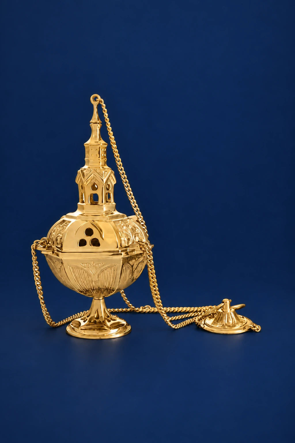 Brass thurible with lid and chain, shown upright with the incense stand beside it