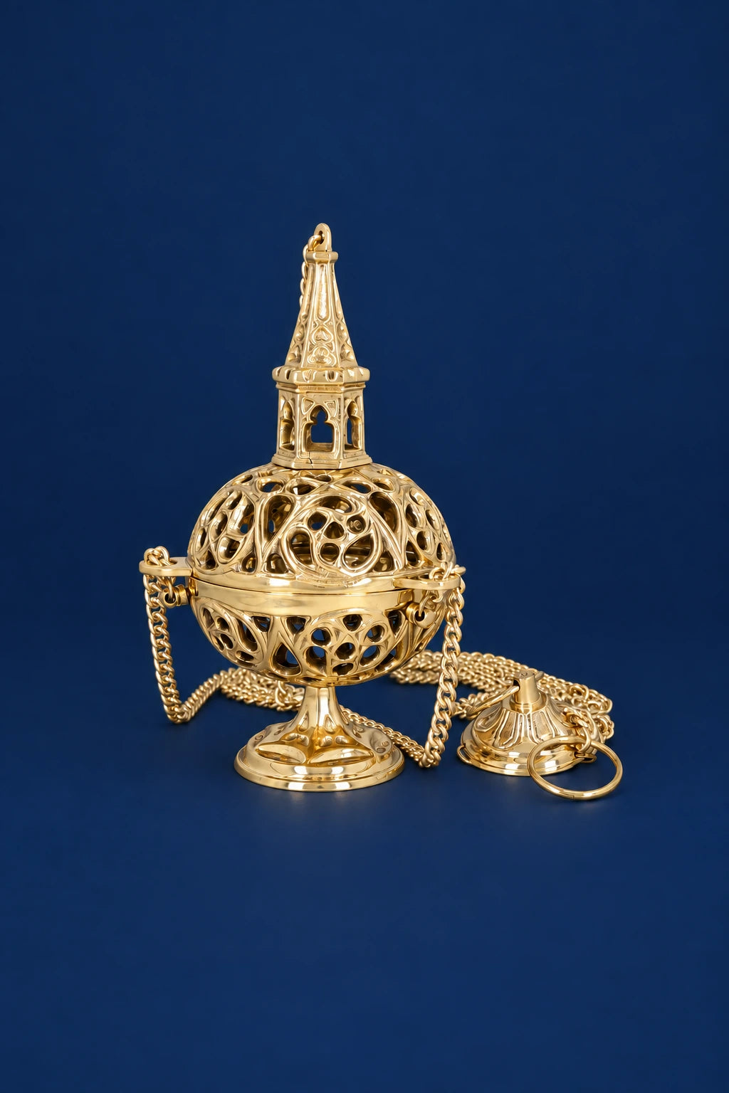 Brass thurible with openwork dome and tower finial, front view on chain stand