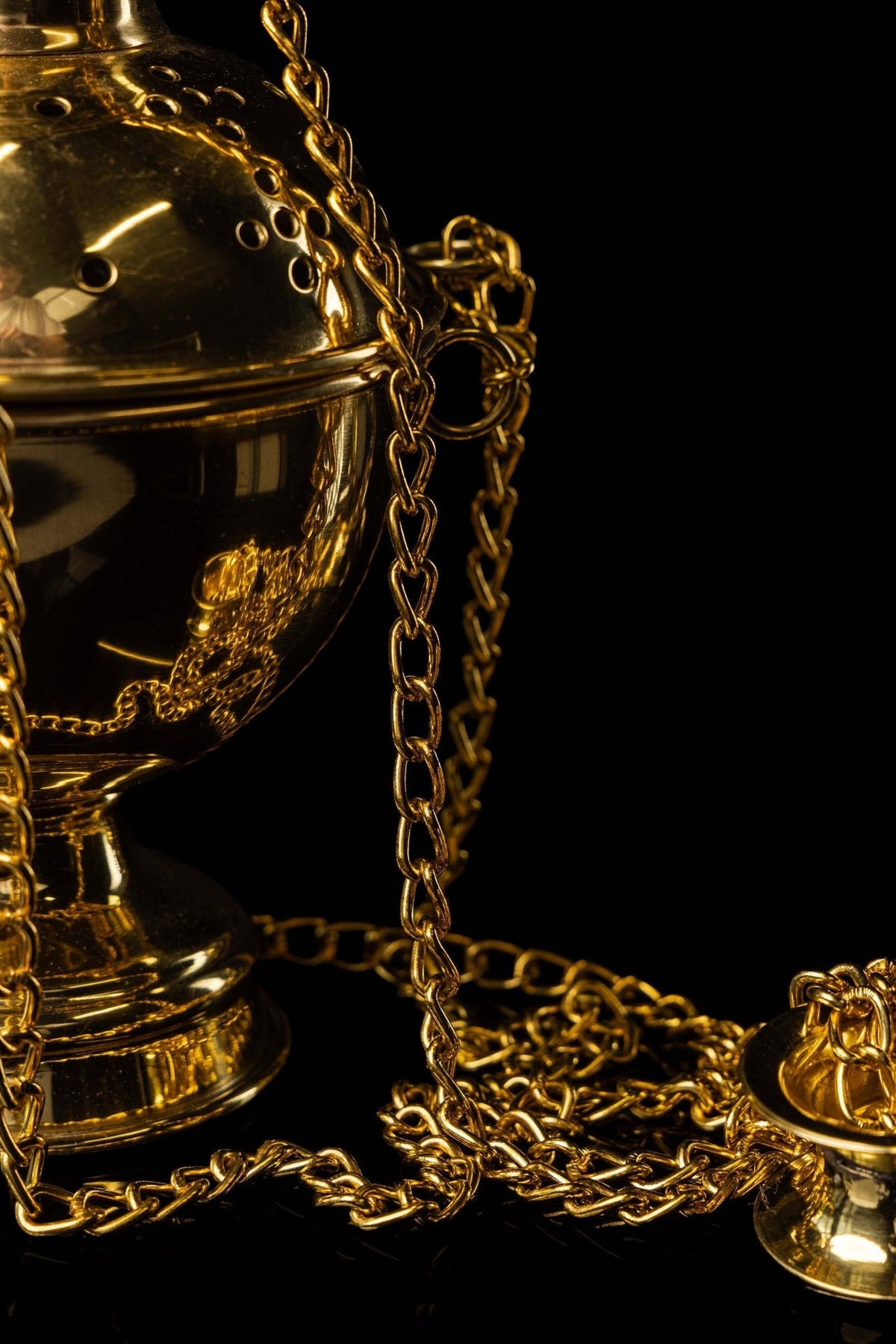 Gold church thurible side detail showing perforations, chain and fittings