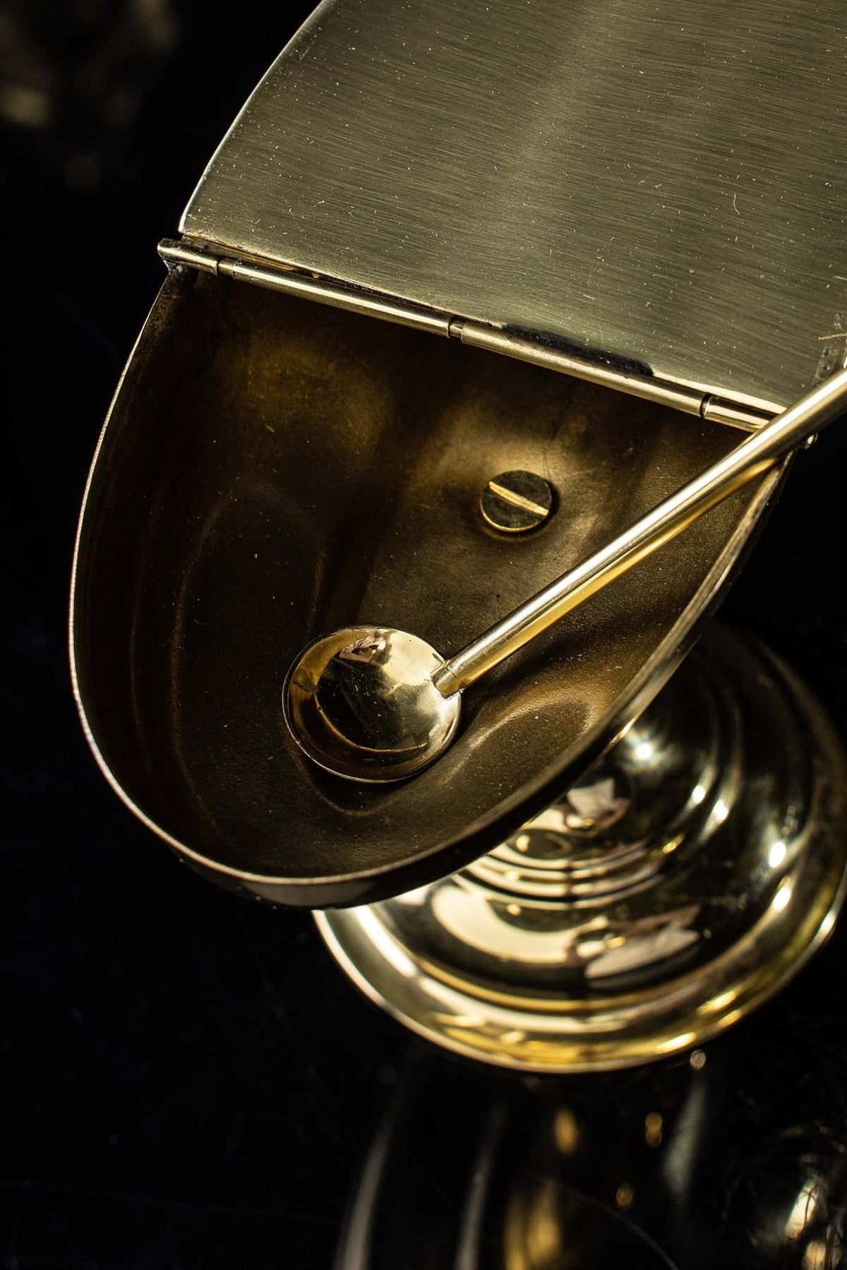 Brass incense boat shown open from above with its spoon inside