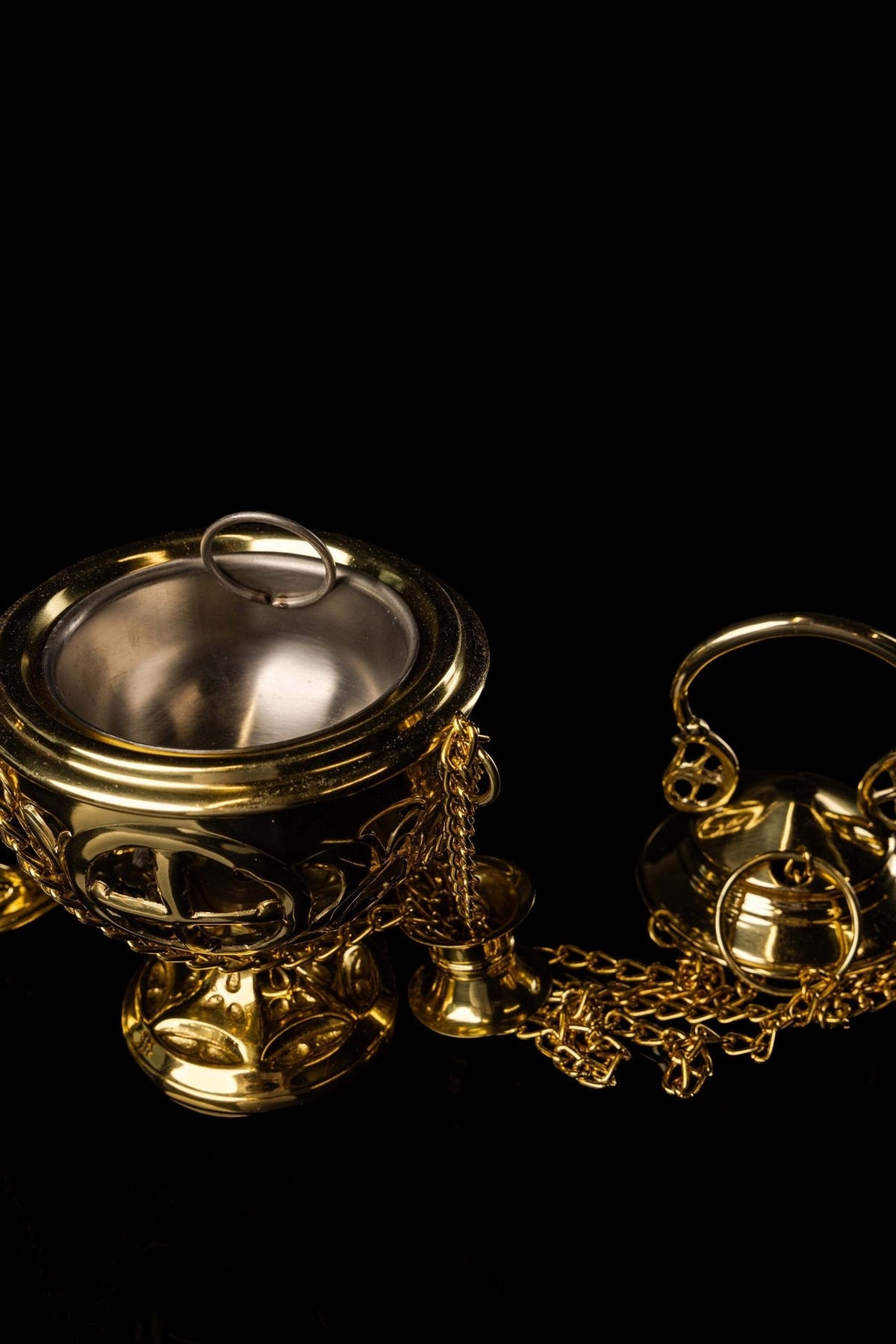 Brass thurible open bowl showing its metal interior and ring handle