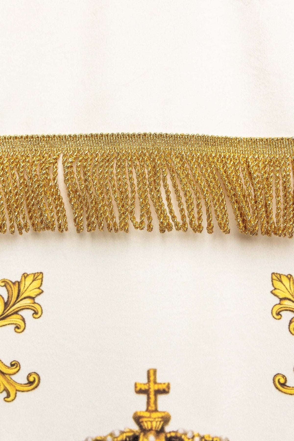 Church banner close-up showing gold fringe trim and printed border