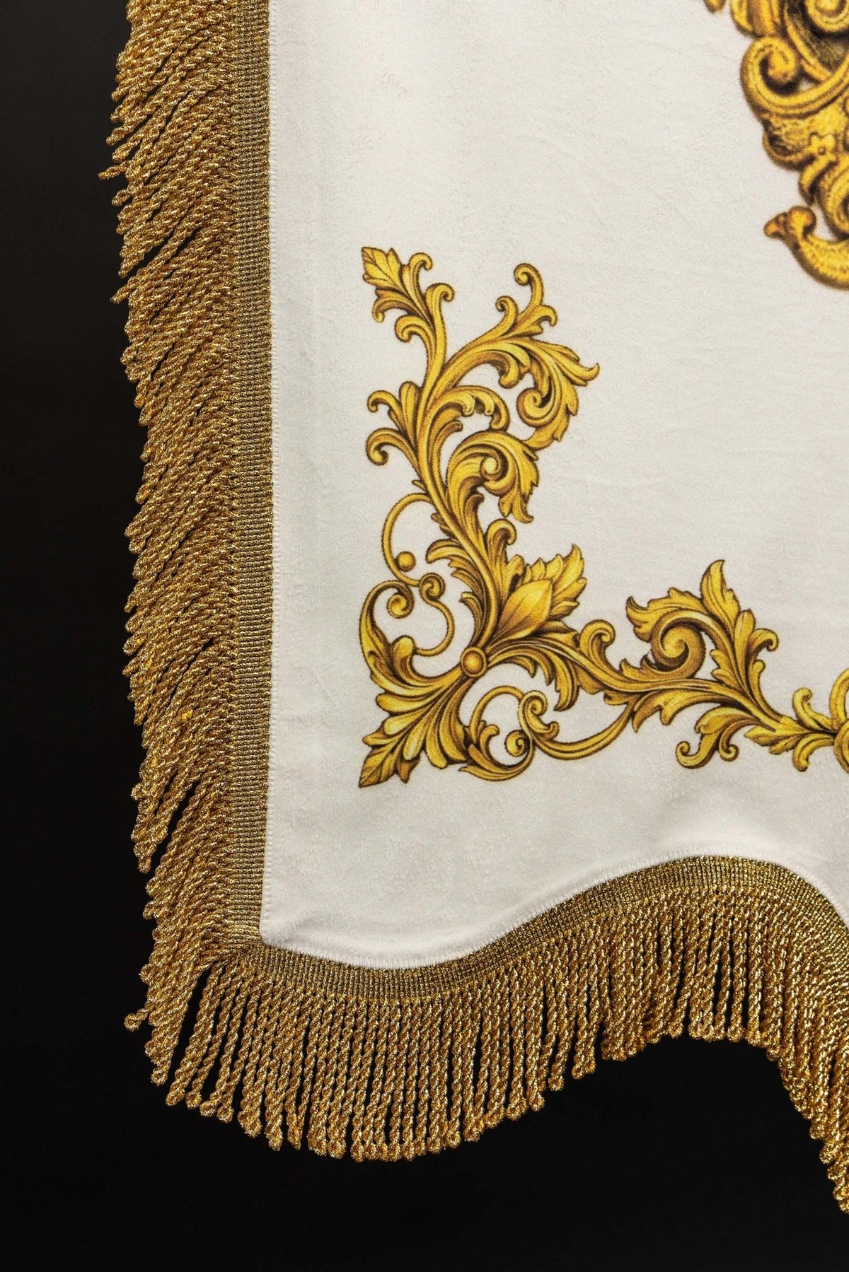 Church banner lower corner with gold scrollwork and fringe