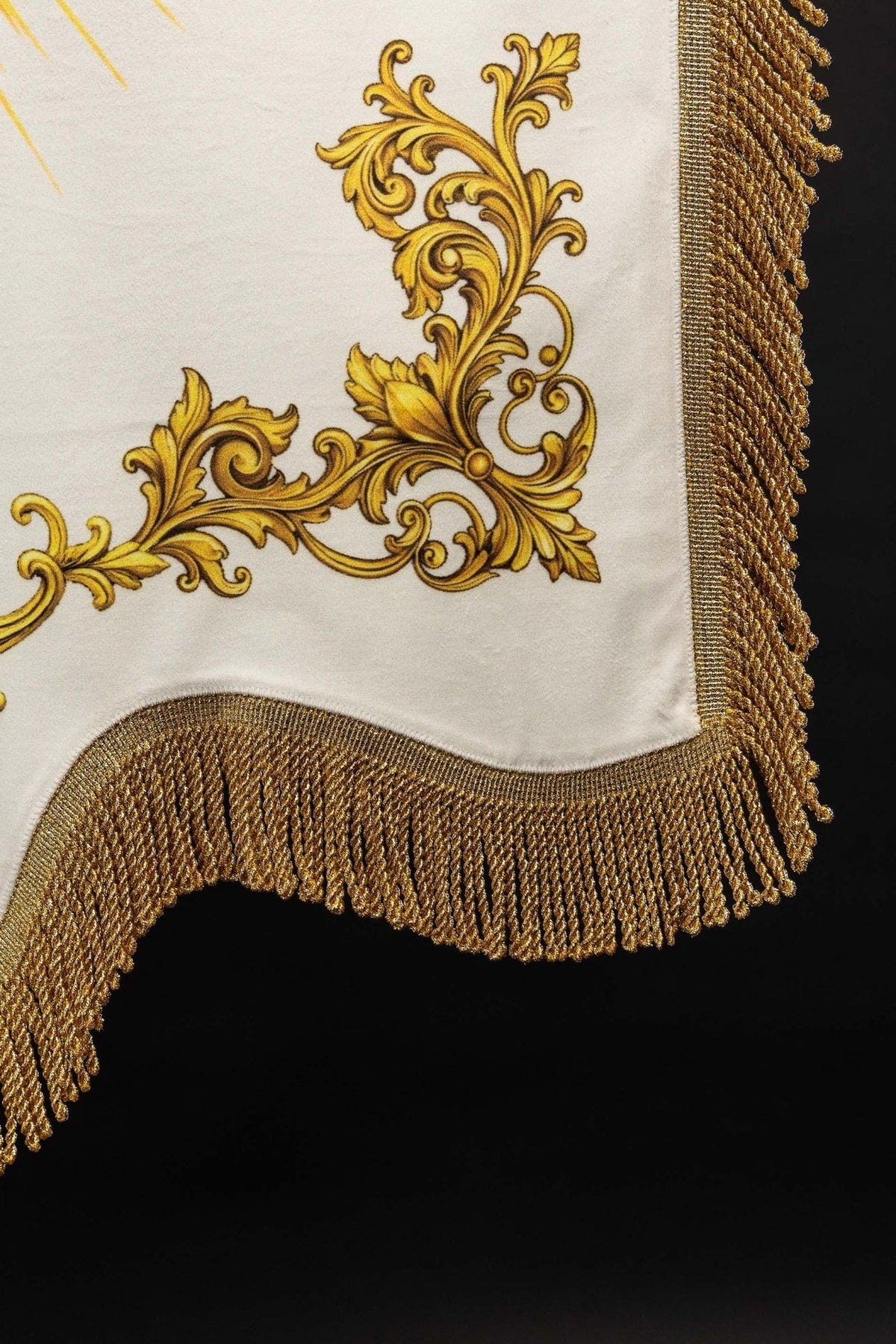 Church banner lower edge showing gold fringe and curved hem