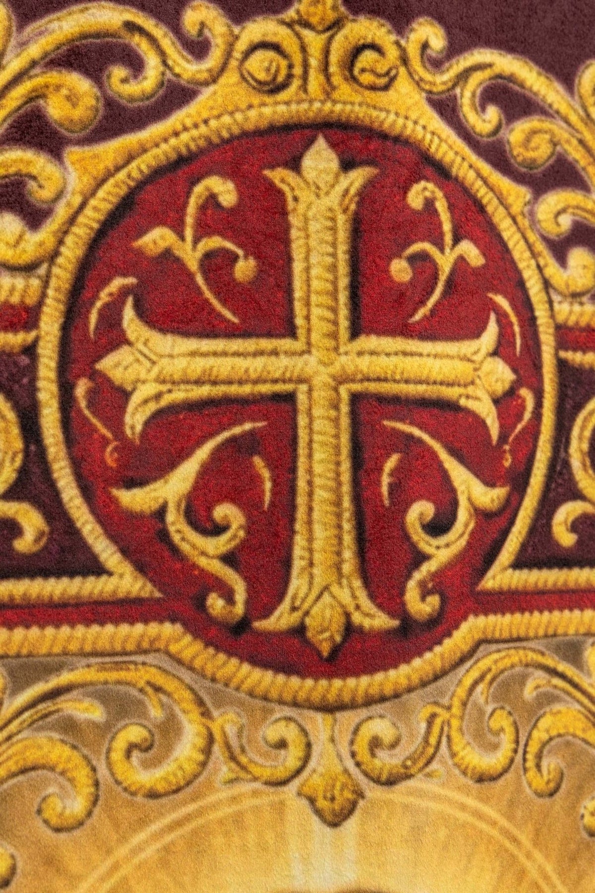 Church banner close-up of gold cross medallion on burgundy fabric