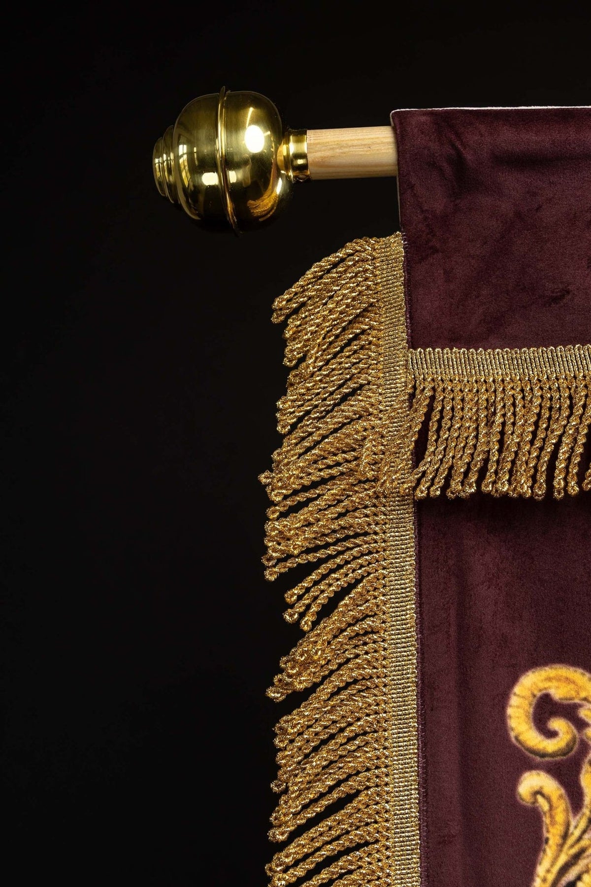 Church banner detail of gold scrollwork, border and fringe
