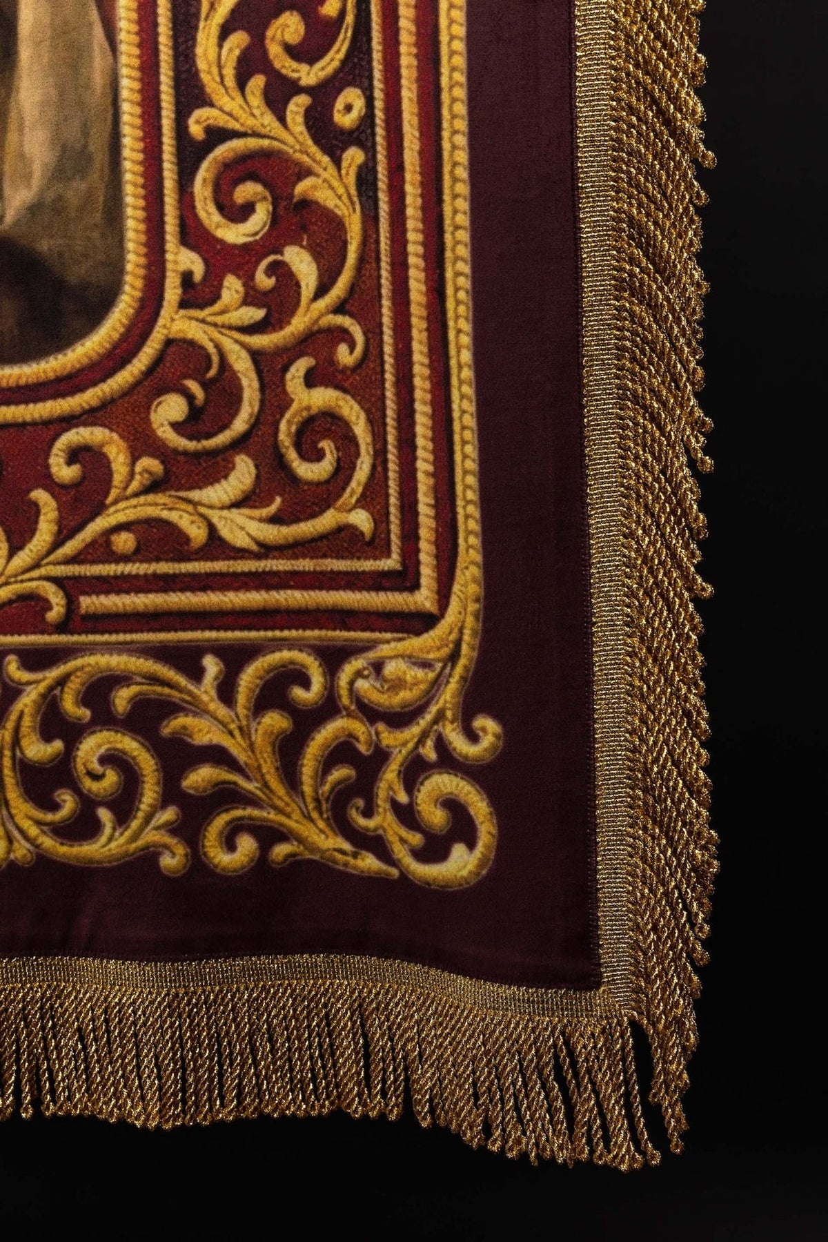 Church banner side detail showing gold fringe, top rod and burgundy fabric