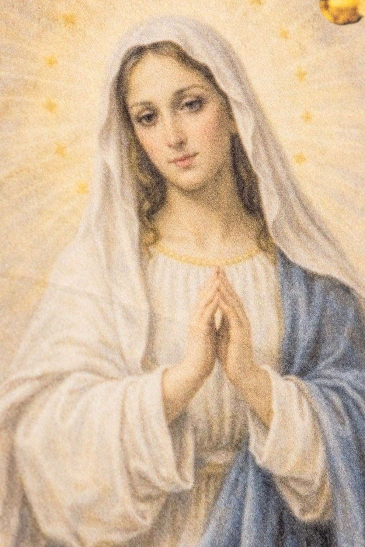 Church banner close-up of Our Lady in white and blue within a gold frame
