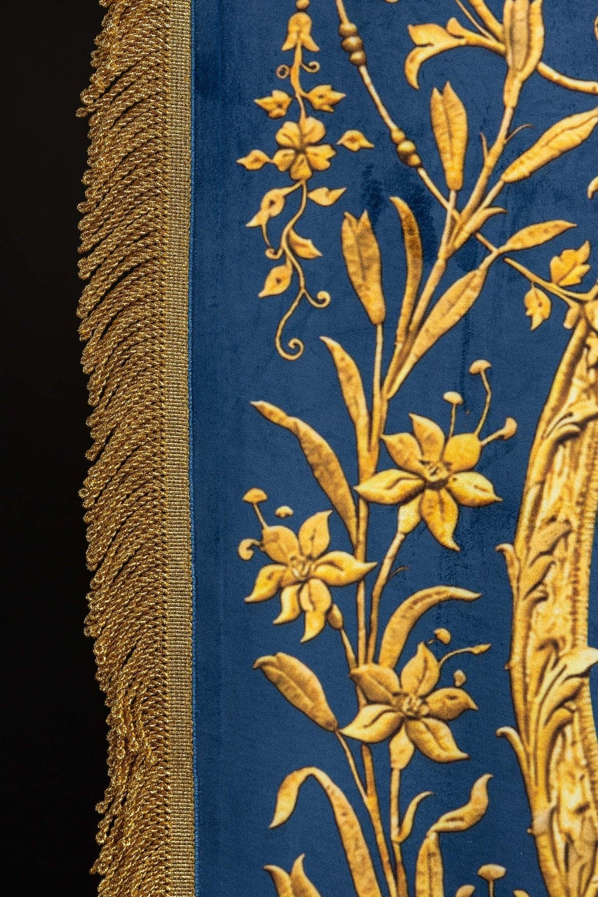 Church banner reverse close-up showing gold Marian monogram and crown
