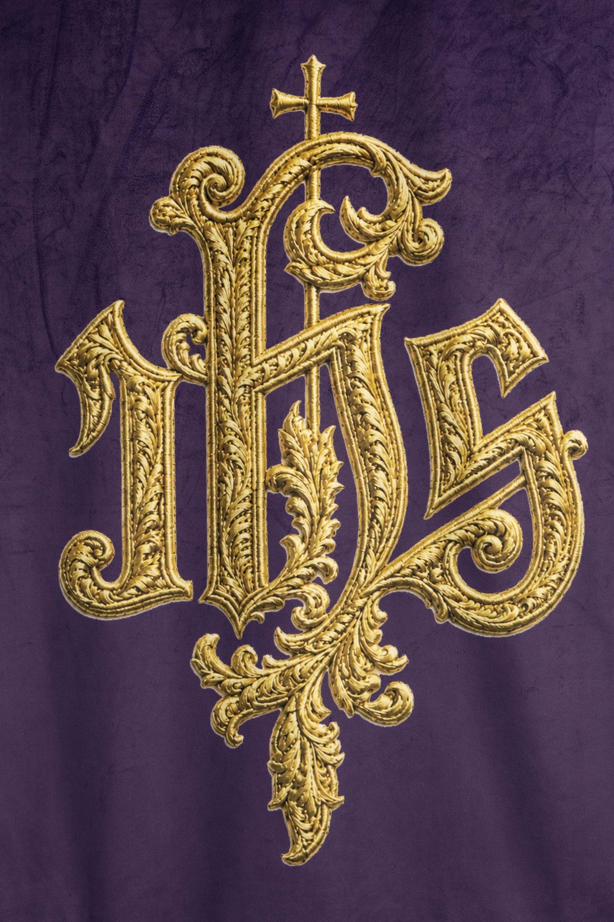 Close-up of church banner front showing ornate gold IHS design