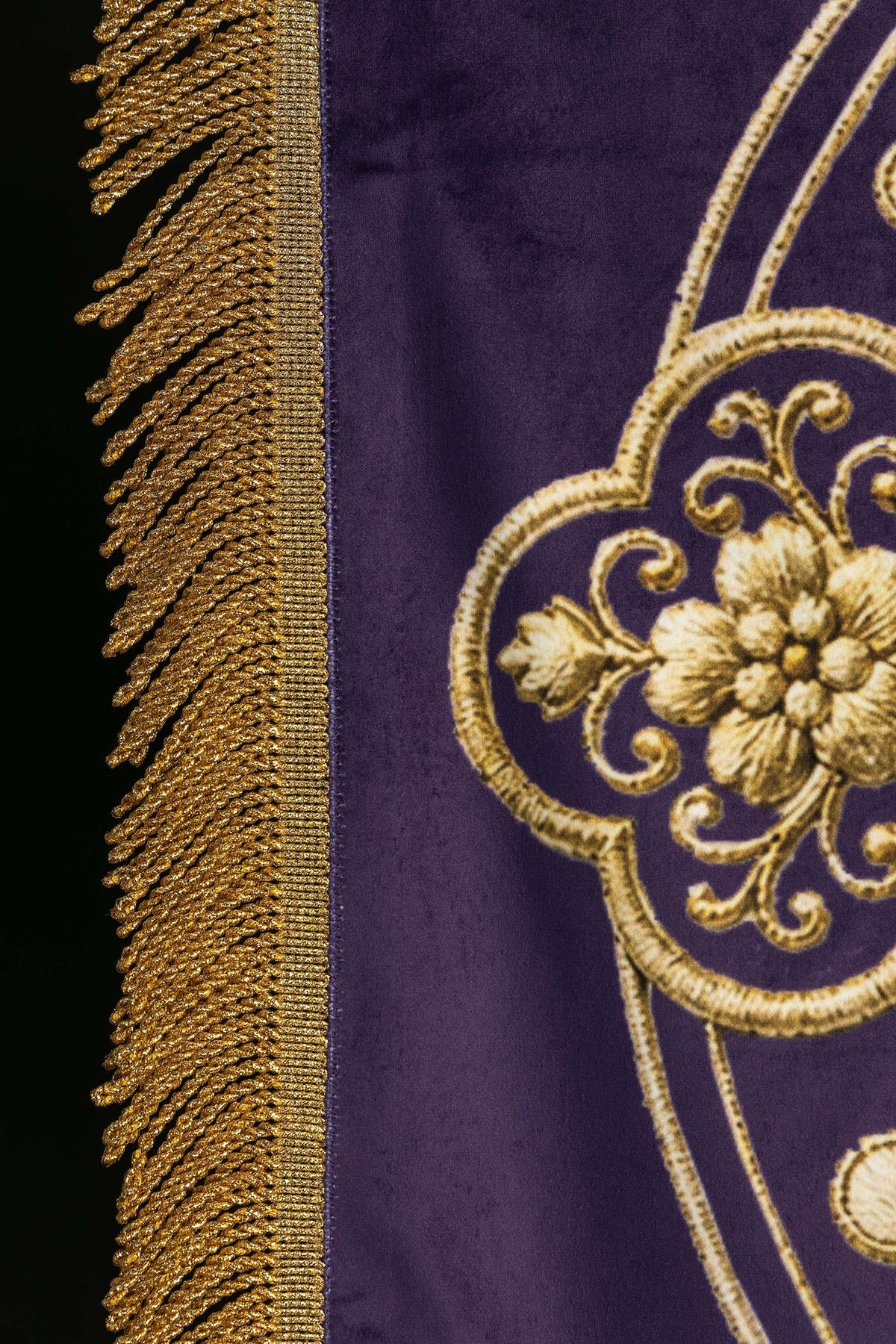 Church banner close-up showing gold fringe and floral cross detail