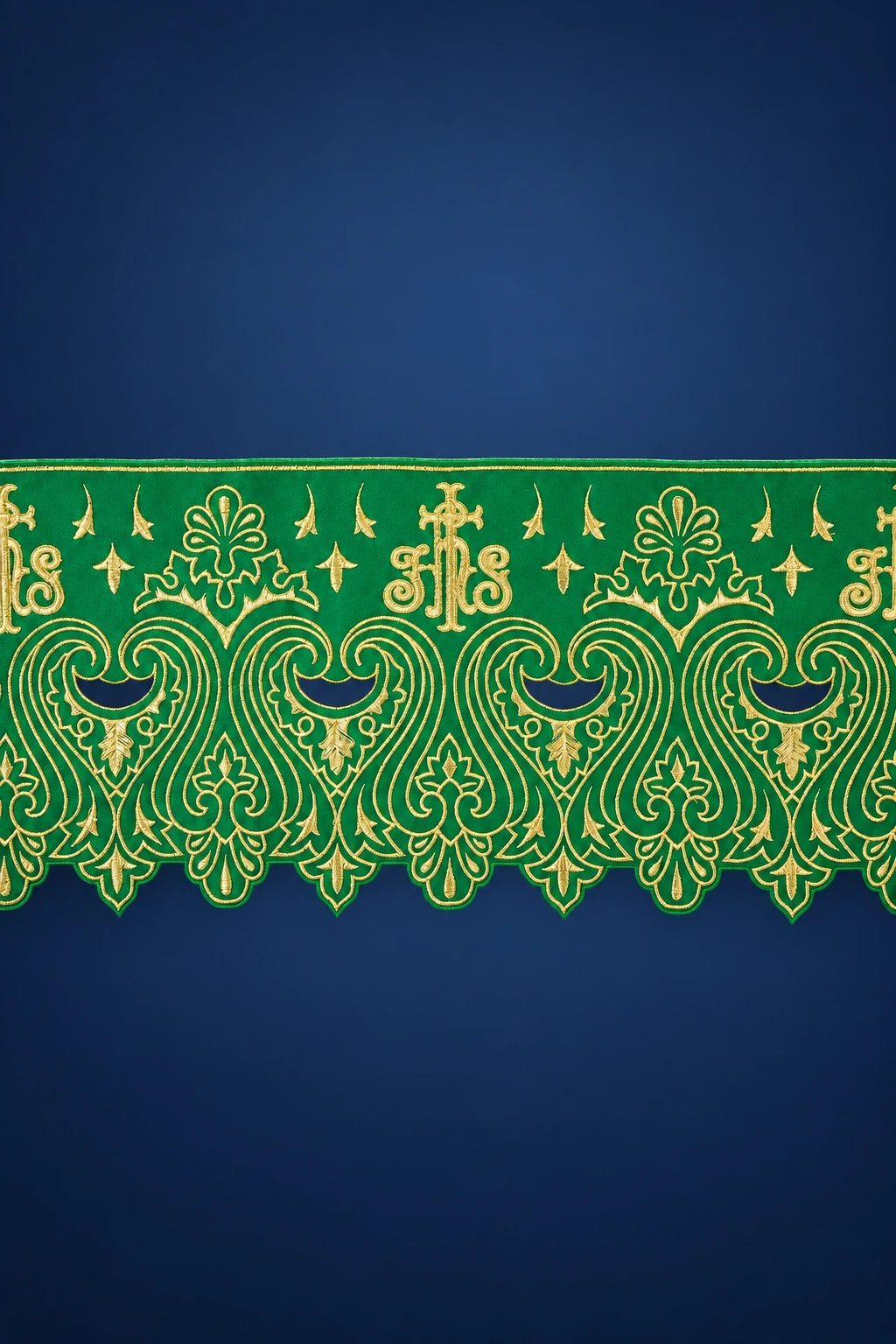 Close-up of green altar lace with gold IHS and ornate floral embroidery along the edge