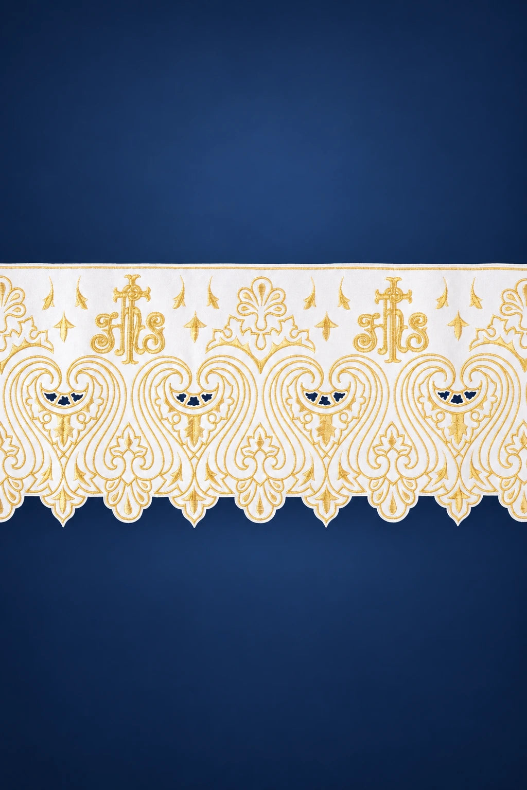 Close-up of white altar lace with gold IHS and scalloped embroidery trim