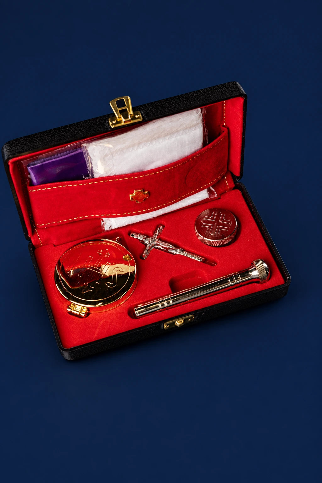 Burse with Liturgical Supplies open, showing red lining, white linens, crucifix, pyx and aspergillum