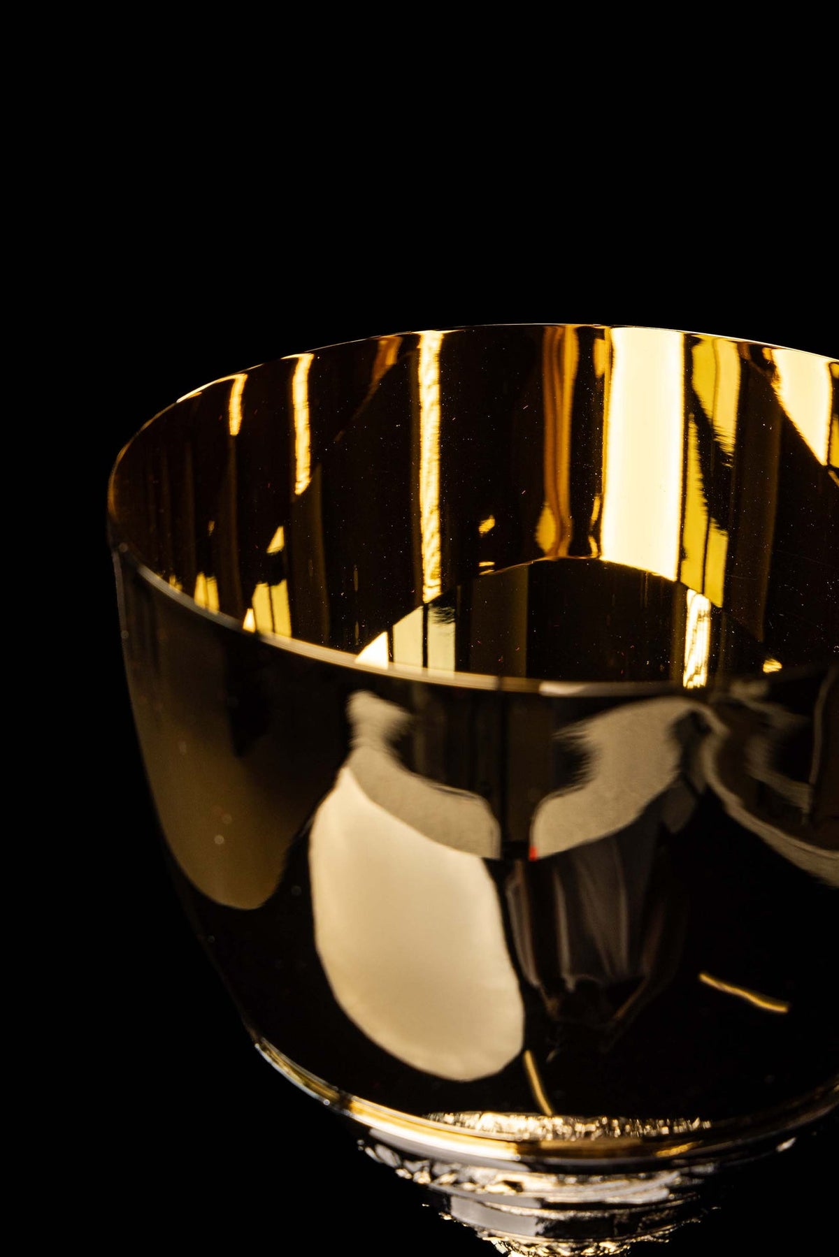 Gold and silver chalice close-up of the polished gold cup with reflective interior