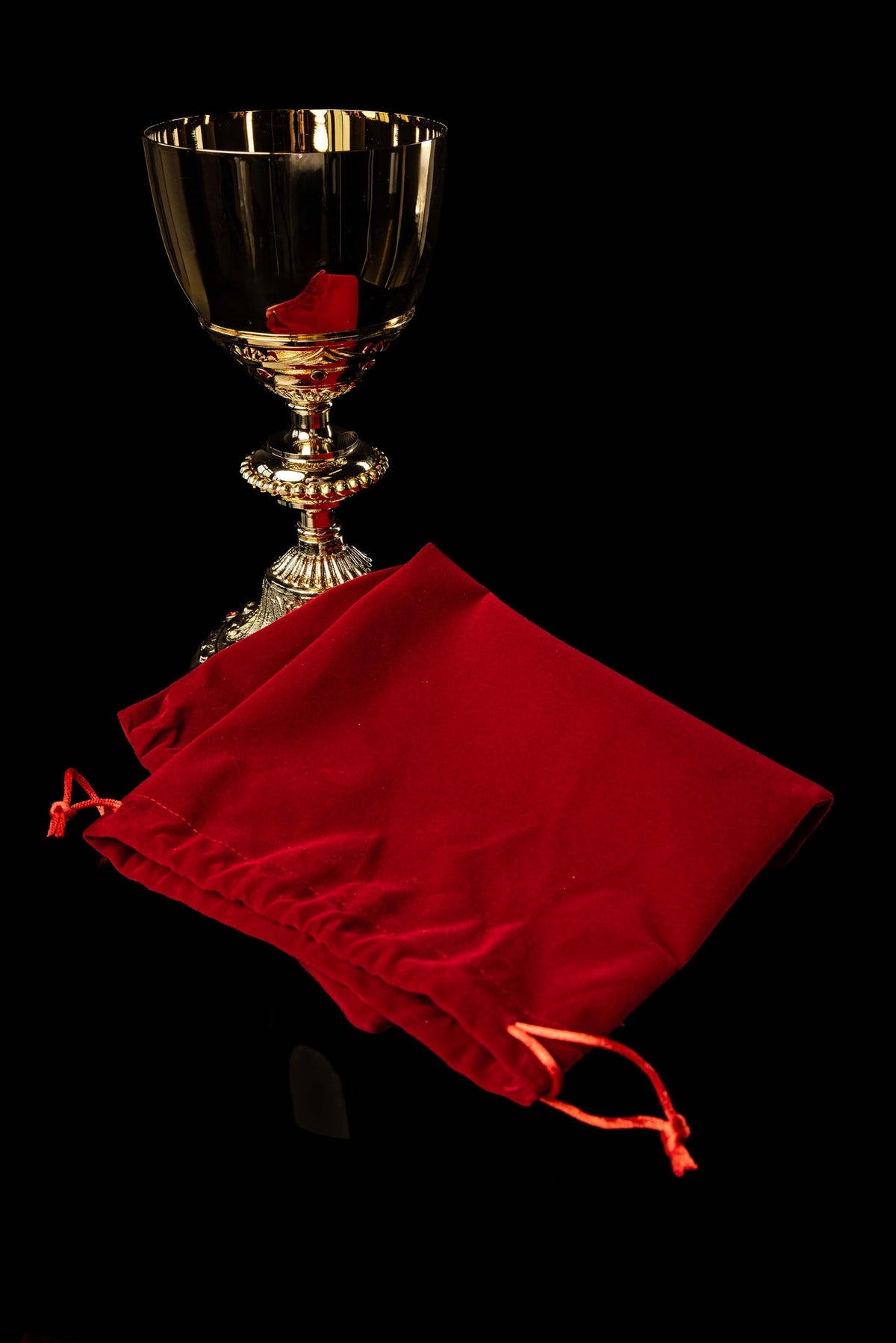 Gold-plated Baroque-style chalice with red velvet storage bag