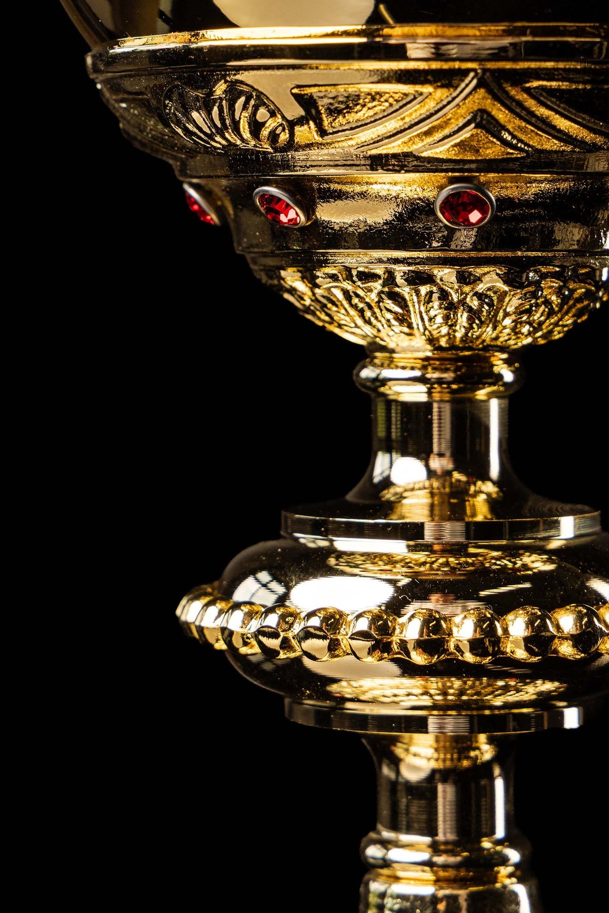 Gold-plated chalice cup with red imitation rubies and decorative relief