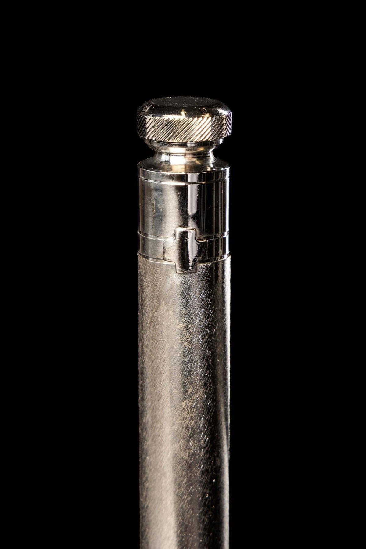 Metal aspergillum, close-up of ridged cap and clasp detail