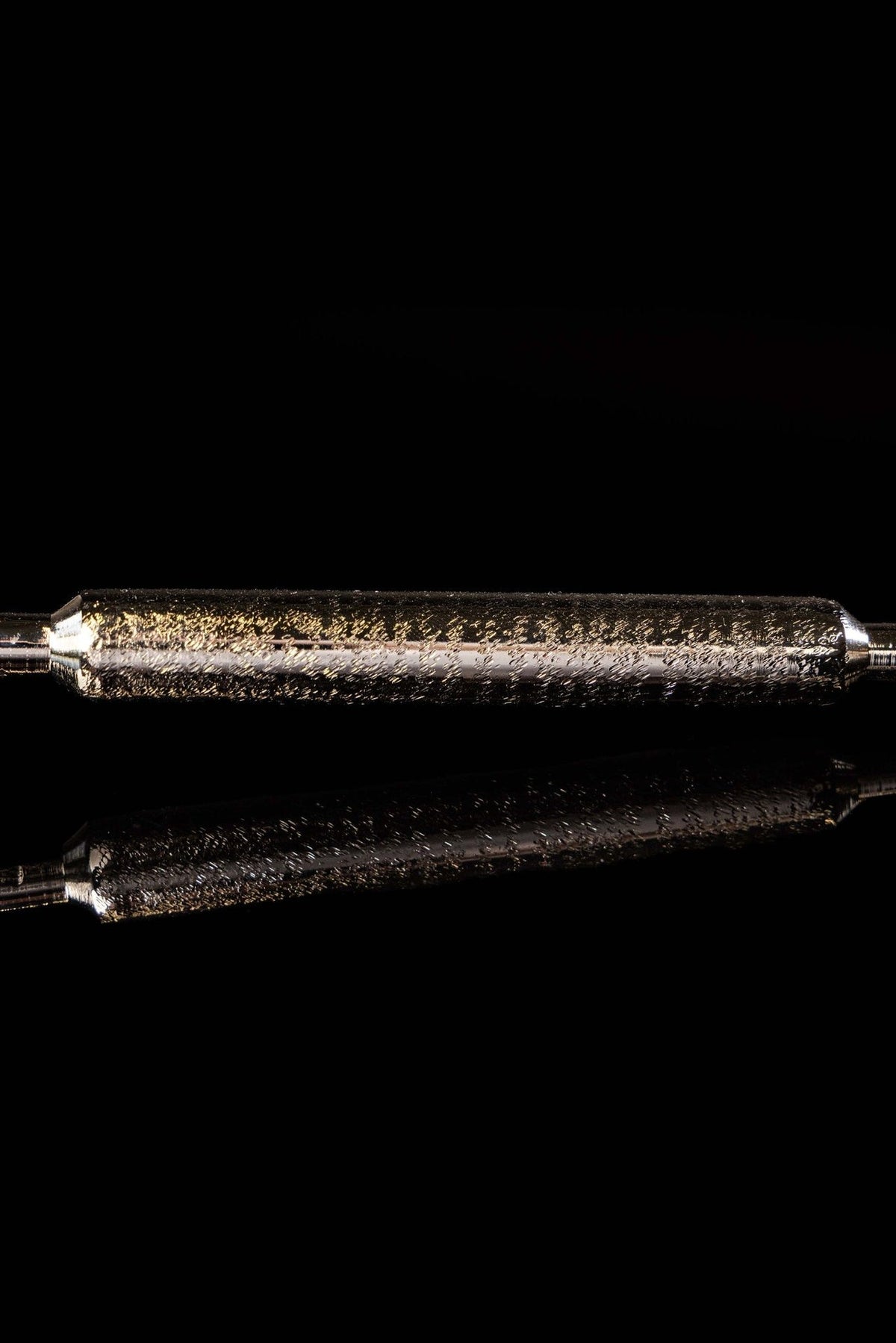 Aspergillum handle close-up with textured silver metal grip