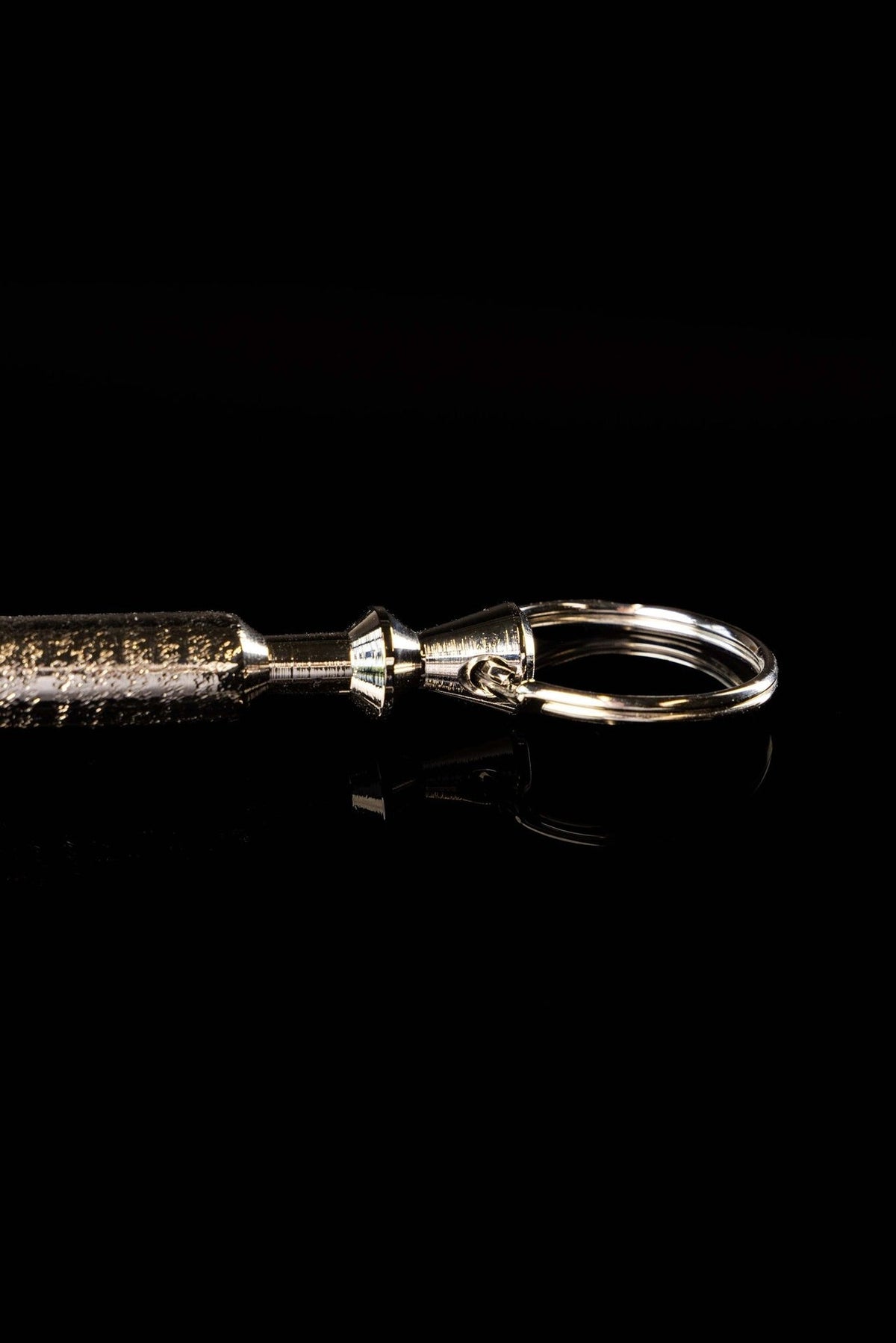 Aspergillum handle end close-up with polished metal ring