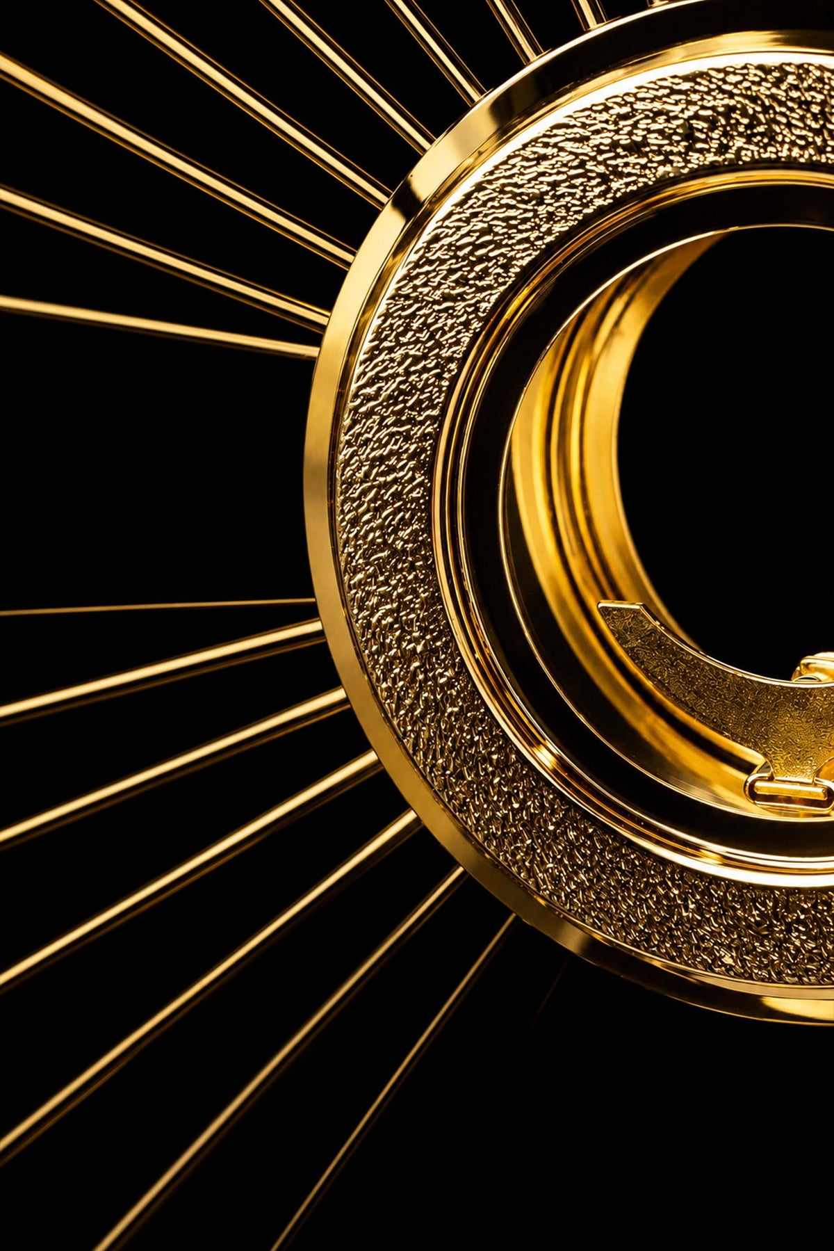 Gold-plated brass monstrance side close-up showing the textured frame and luna