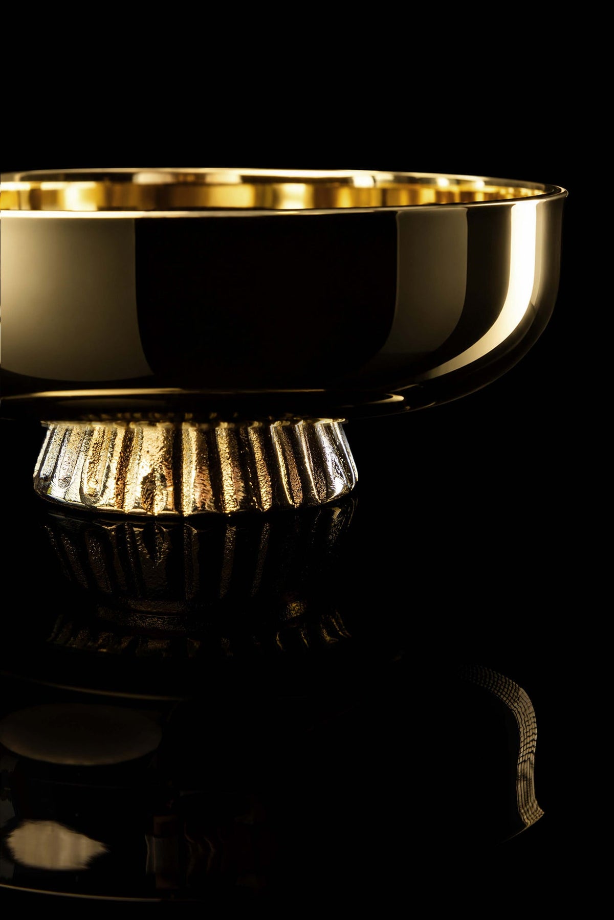 Gold-plated brass paten close-up showing the reflective rim and fluted pedestal