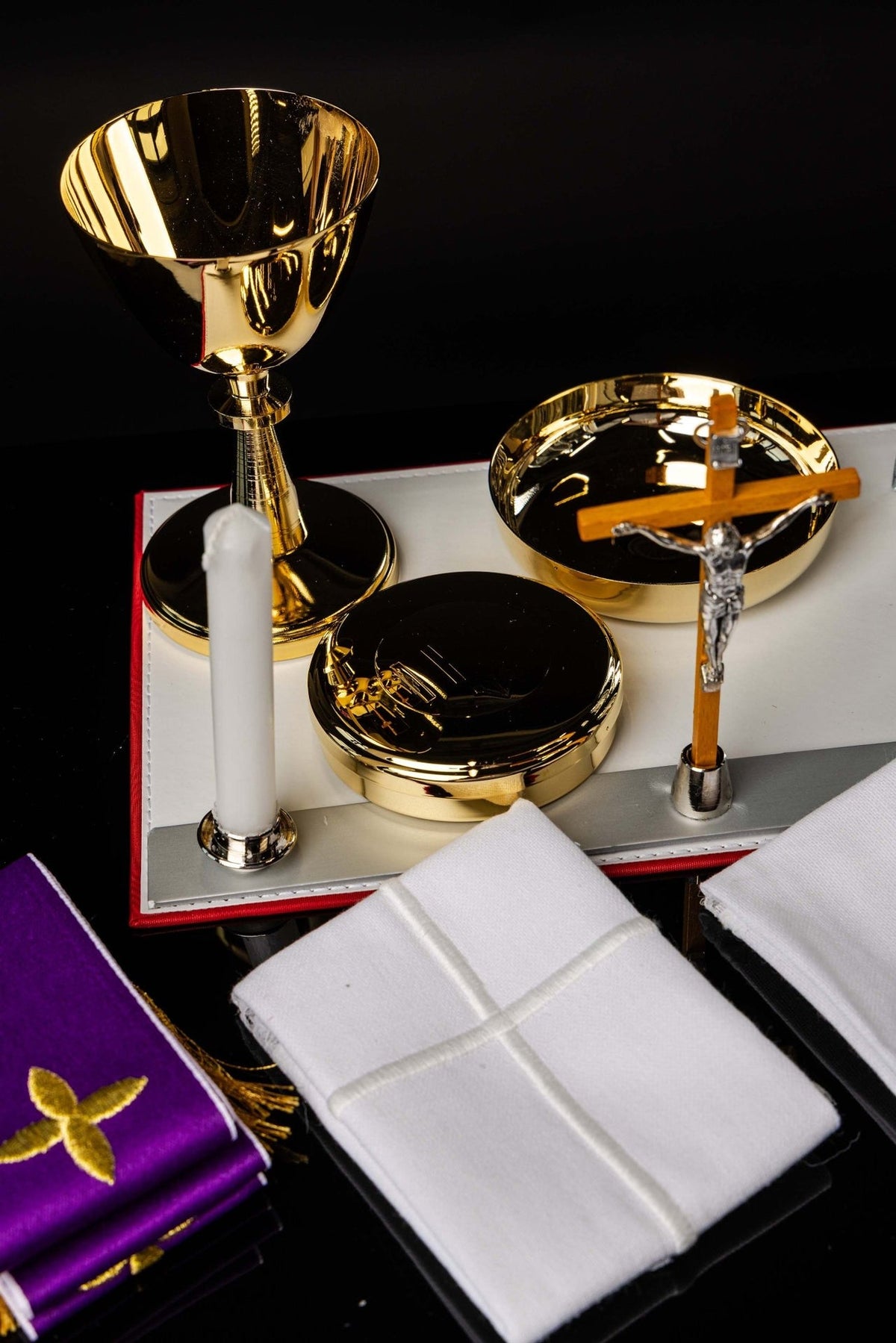 Mission Case with Complete Liturgical Equipment showing gold chalice, paten, cross, linens and candles