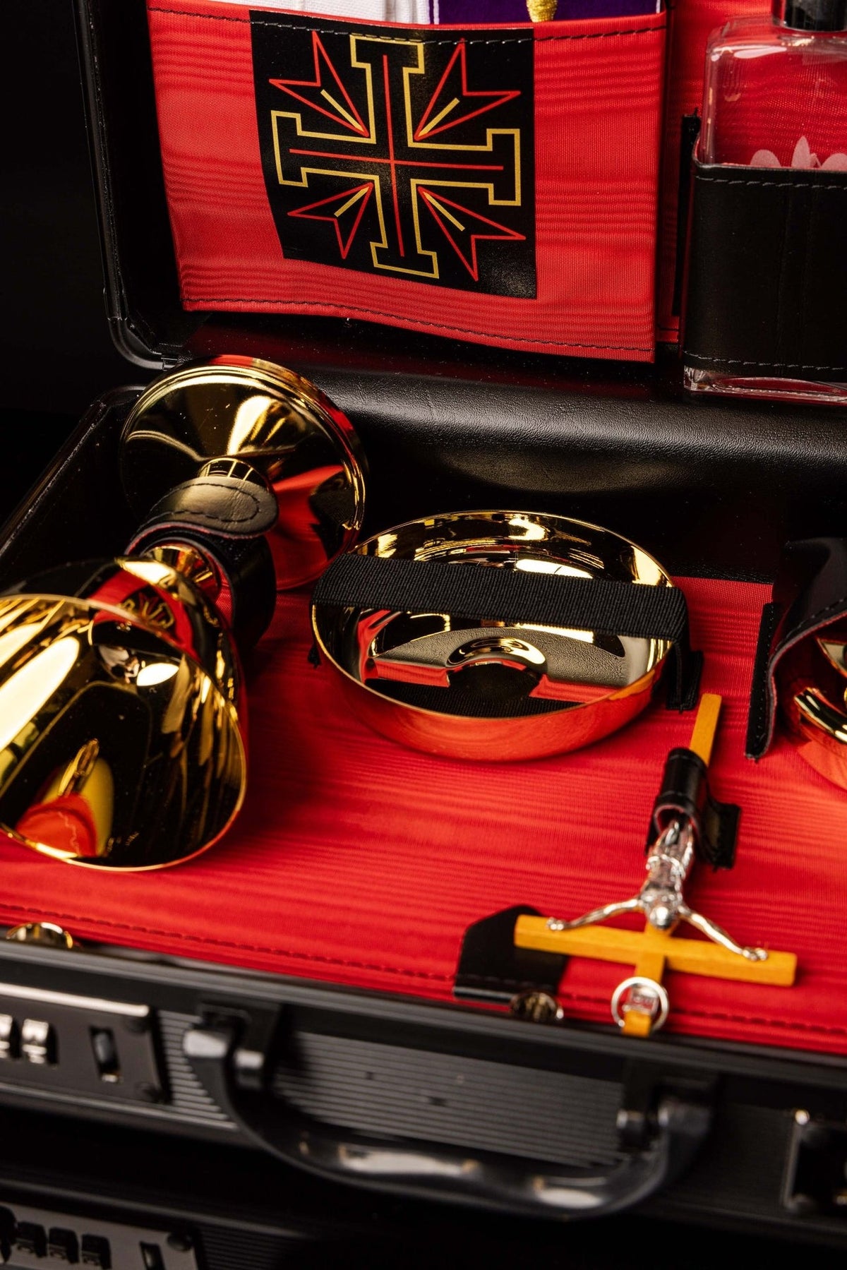 Mission case close-up showing gold vessels, red lining, black straps and cross