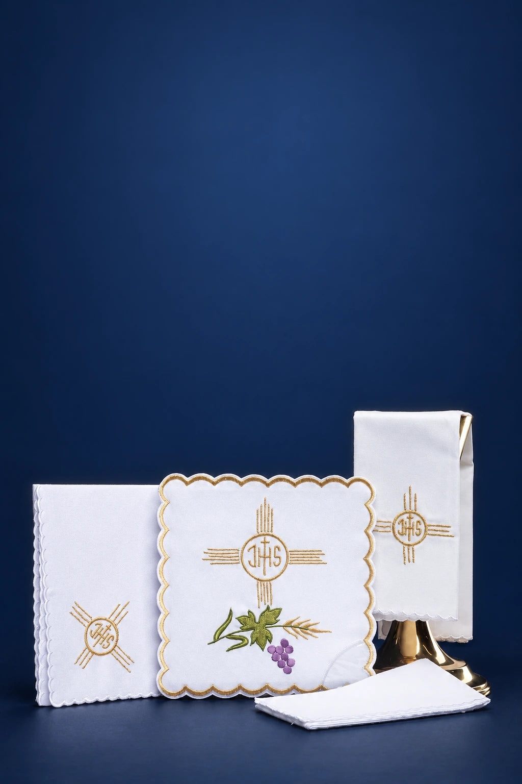 Embroidered altar linen set with gold cross and IHS motif, shown with folded linens and purificator