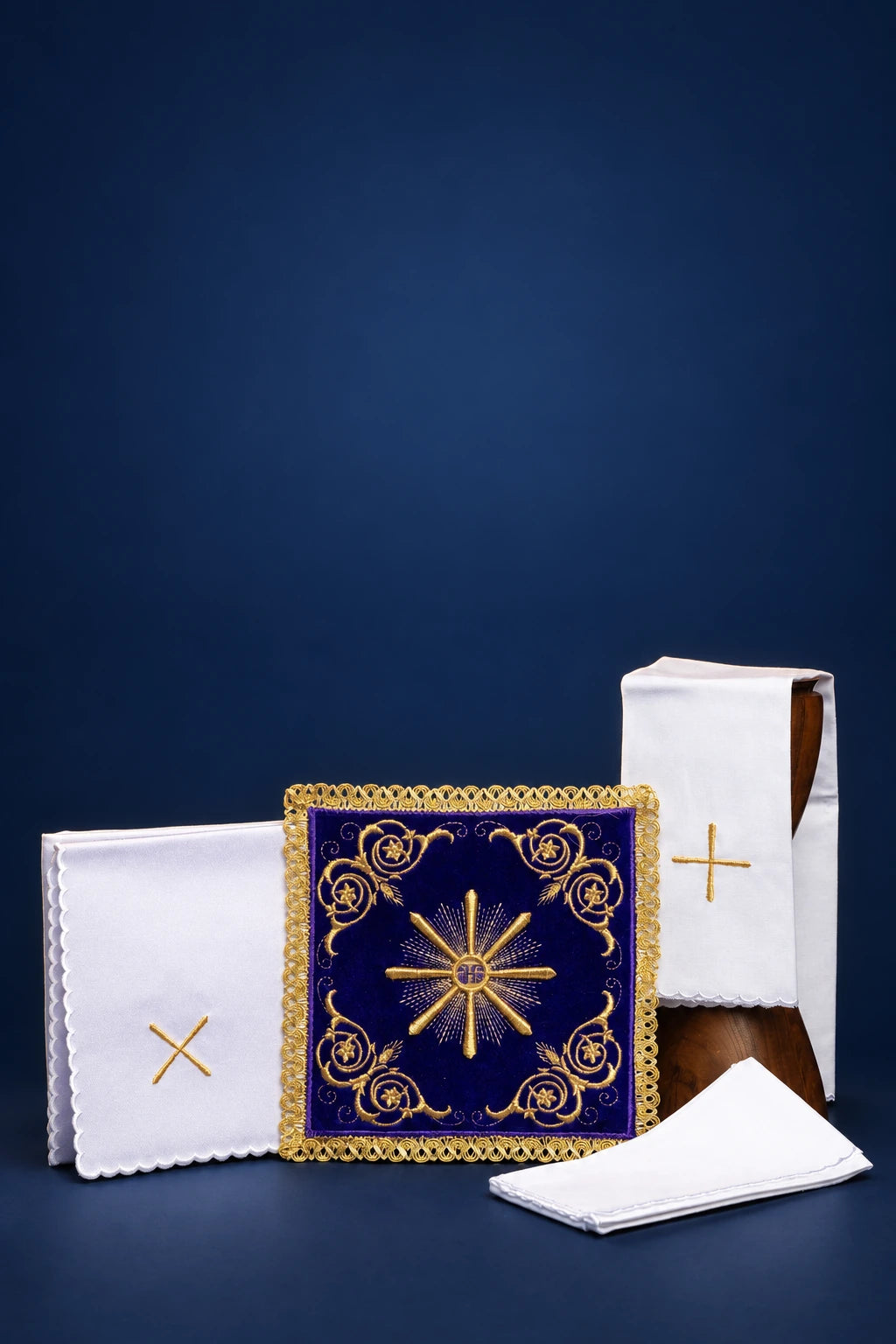Embroidered altar linen set with purple velvet pall, cross motifs, and folded linens