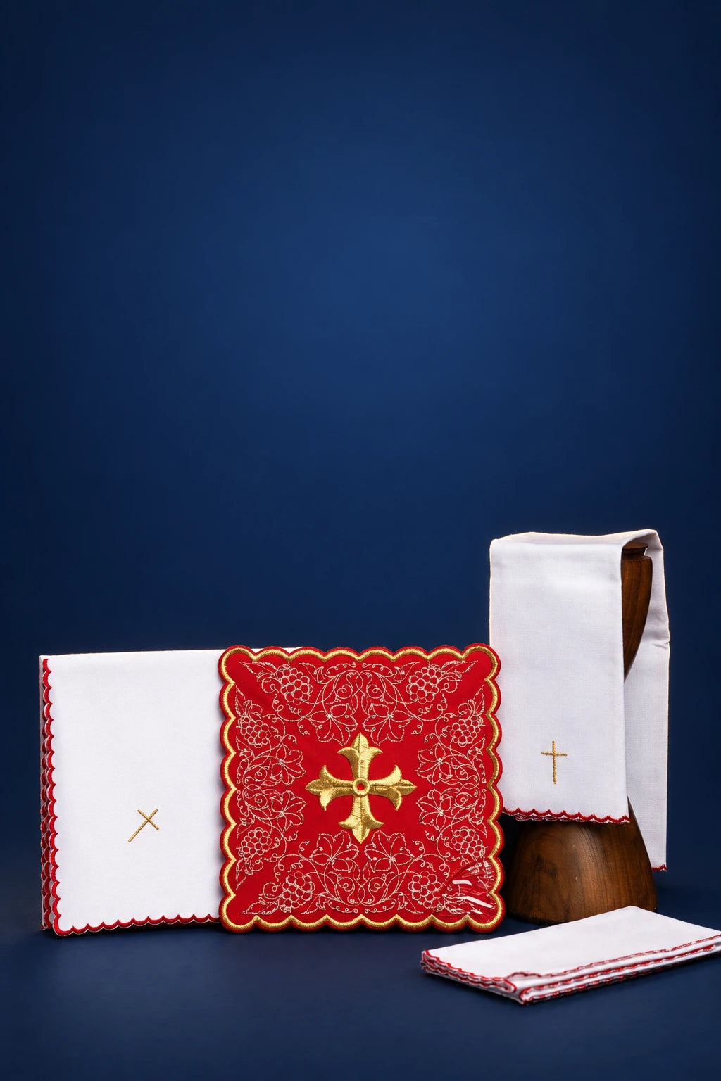 Embroidered altar linen set with red cross motif, folded cloths and veil with gold cross embroidery