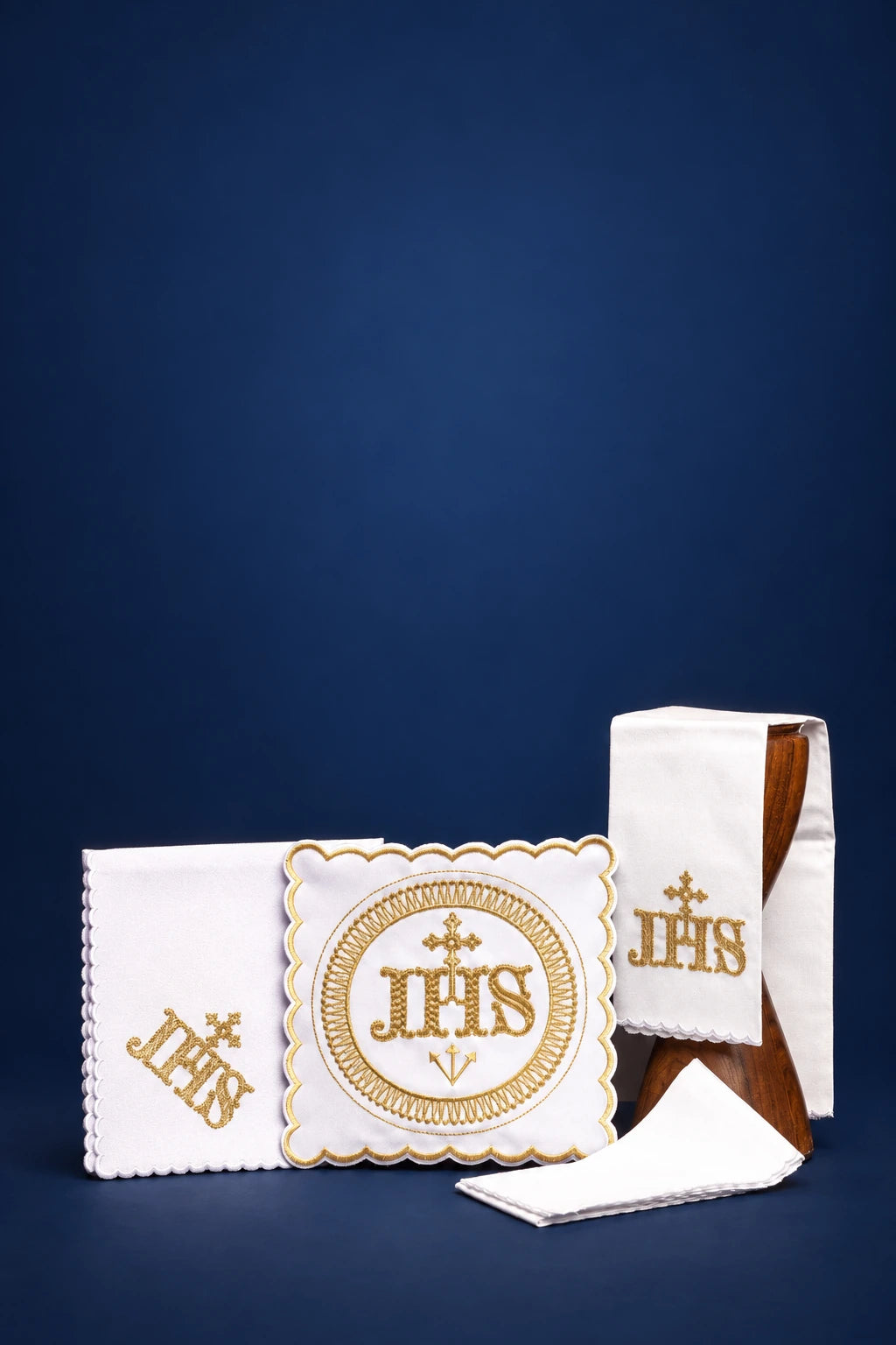 Embroidered linen altar linen set with gold IHS motif, including folded purificator, pall, and corporal